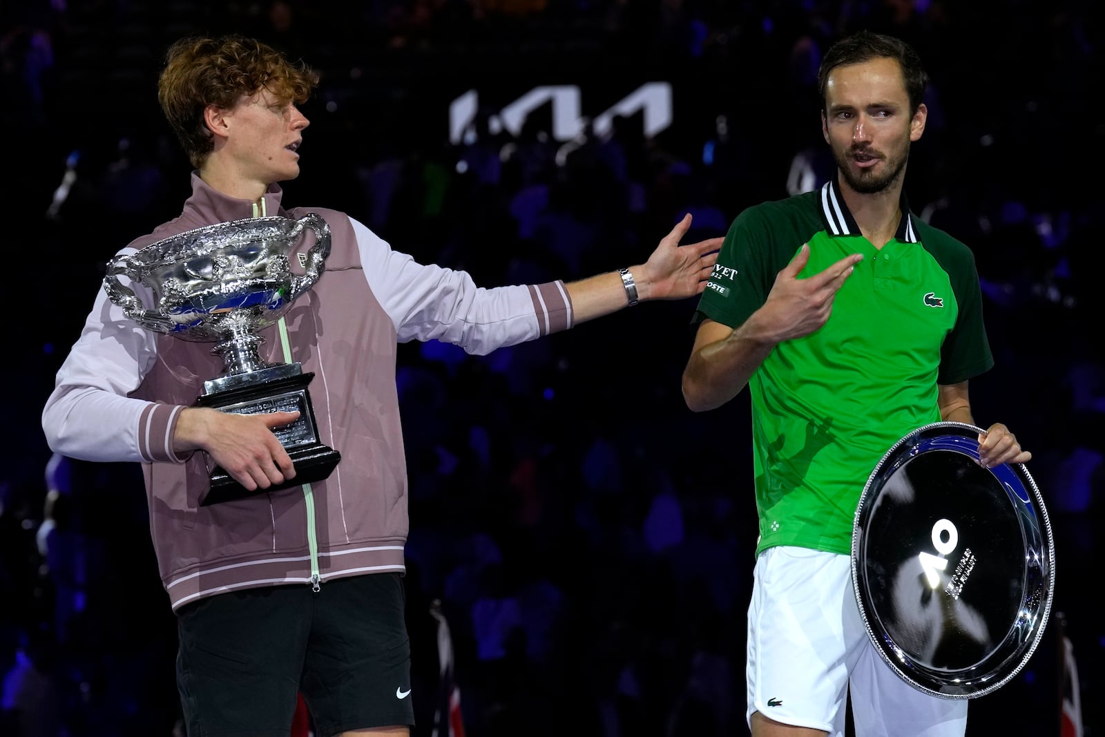 FILE - Jannik Sinner, left, of Italy gestures as he holds the Norman Brookes Challenge Cup after defeating Daniil Medvedev, right, of Russia in the men's singles final at the Australian Open tennis championships at Melbourne Park, in Melbourne, Australia, Jan. 28, 2024. (AP Photo/Andy Wong, File)