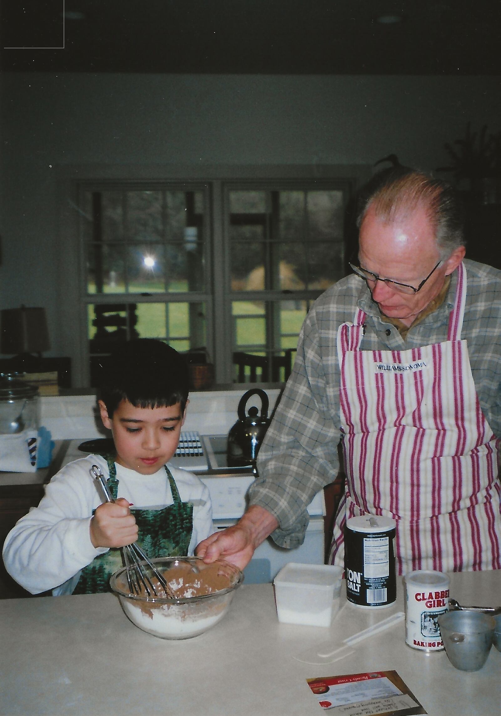 Nathan Hess baking in the kitchen with his grandfather George Hess.