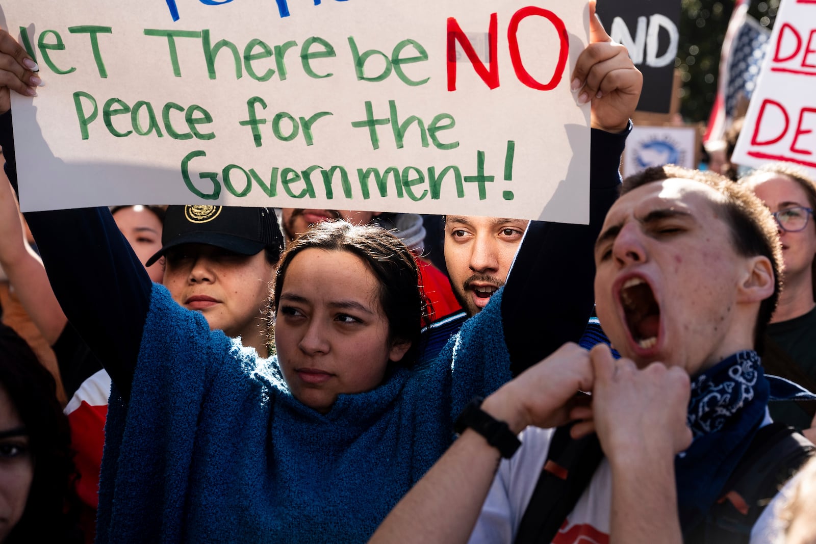 Michael Martinez joins several hundred demonstrators rallying against President Donald Trump outside the California State Capitol on Wednesday, Feb. 5, 2025, in Sacramento, Calif. (AP Photo/Noah Berger)