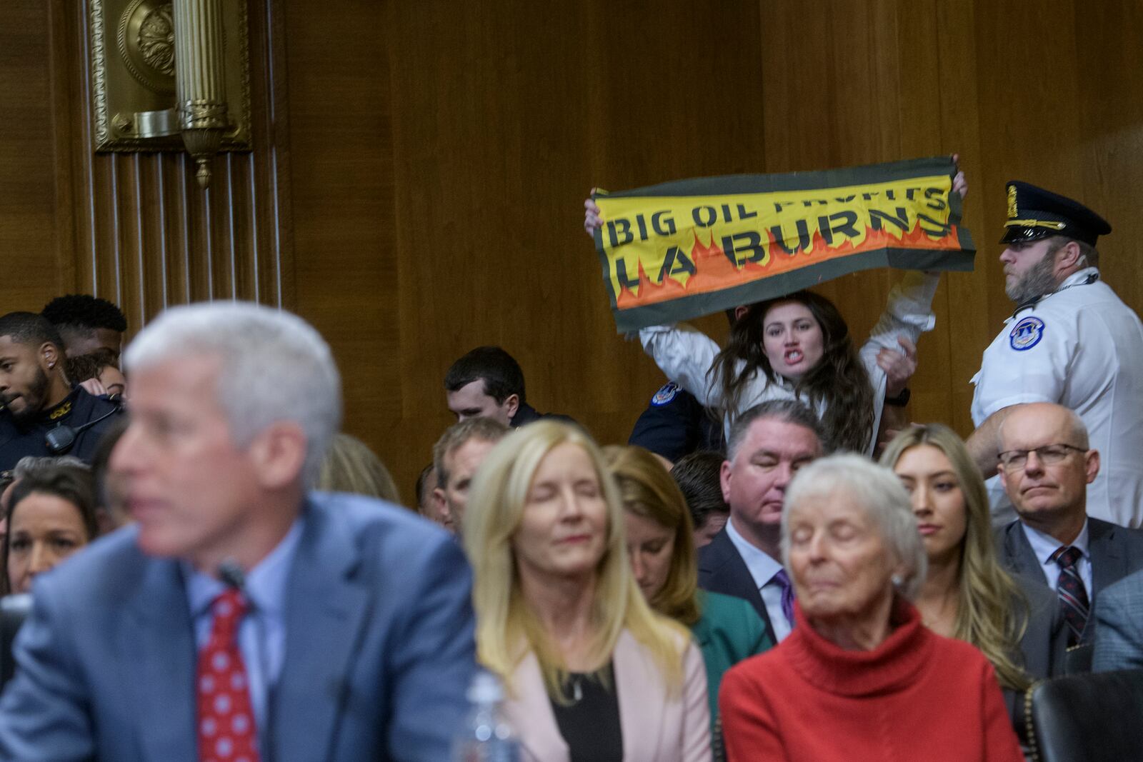 A protestor interrupts Chris Wright, President-elect Donald Trump's nominee to be Secretary of Energy, as he testifies during a Senate Committee on Energy and Natural Resources hearing for his pending confirmation, on Capitol Hill, Wednesday, Jan. 15, 2025, in Washington. (AP Photo/Rod Lamkey, Jr.)