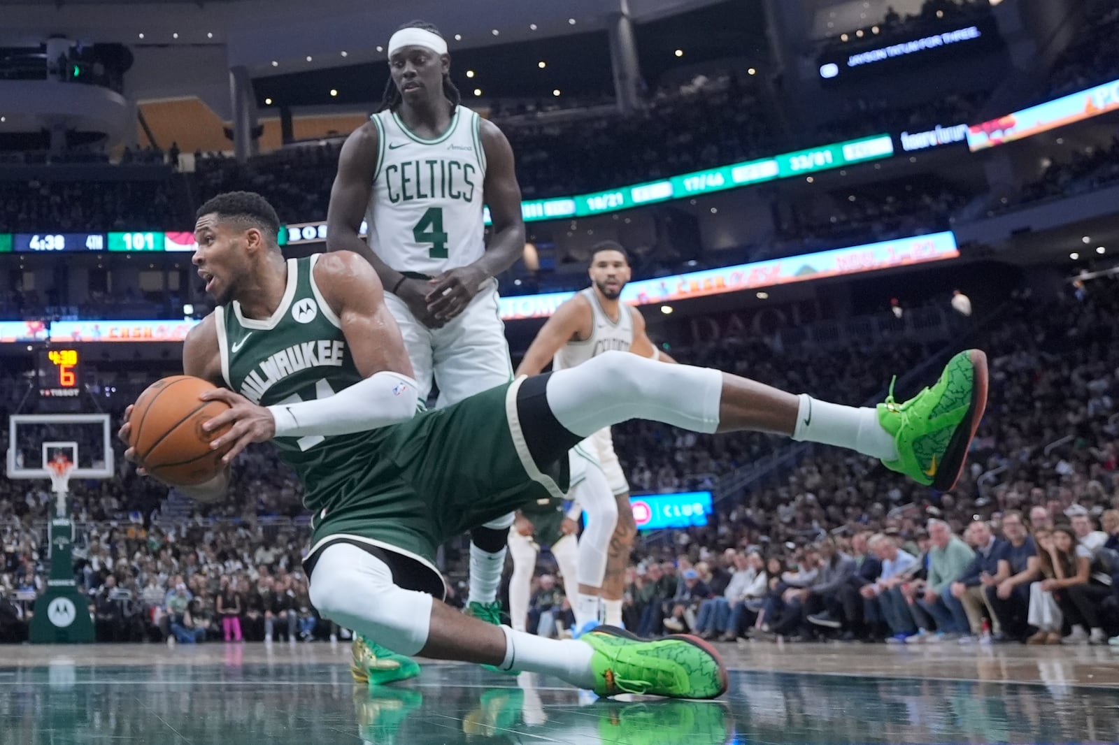 Milwaukee Bucks' Giannis Antetokounmpo falls in front of Boston Celtics' Jrue Holiday during the second half of an NBA basketball game Sunday, Nov. 10, 2024, in Milwaukee. (AP Photo/Morry Gash)