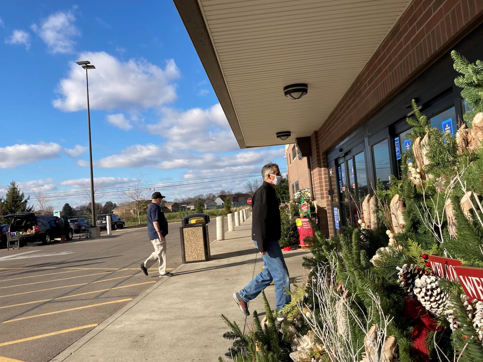 Customers wearing masks enter Kroger in Troy.