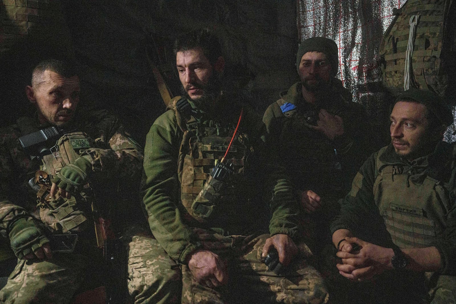 Ukrainian servicemen of 117th Separate Heavy Mechanized Brigade sit in the dugout after firing from their AS-90 self-propelled artillery vehicle towards Russian positions at the front line on Pokrovsk direction, Donetsk region, Ukraine, Wednesday, Dec. 23, 2024. (AP Photo/Evgeniy Maloletka)