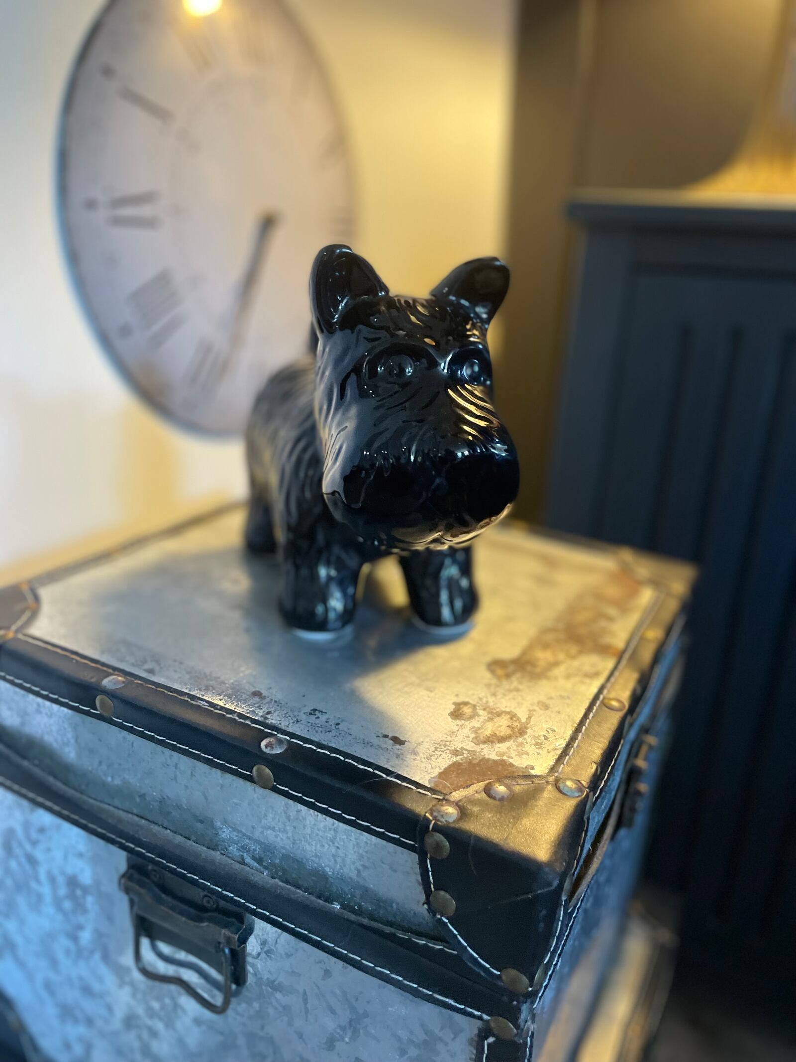 A small figurine of a Scottish terrier stands atop a stack of vintage trunks in Terri Miller's living room. Photo by Robin McMacken