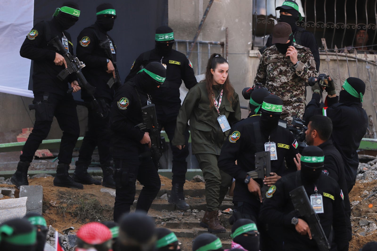 Israeli soldier Agam Beger walks next to masked Islamic Jihad militants as she is handed over to the Red Cross at the Jabalya refugee camp in Gaza City, Thursday Jan. 30, 2025.(AP Photo/Mohammed Hajjar)