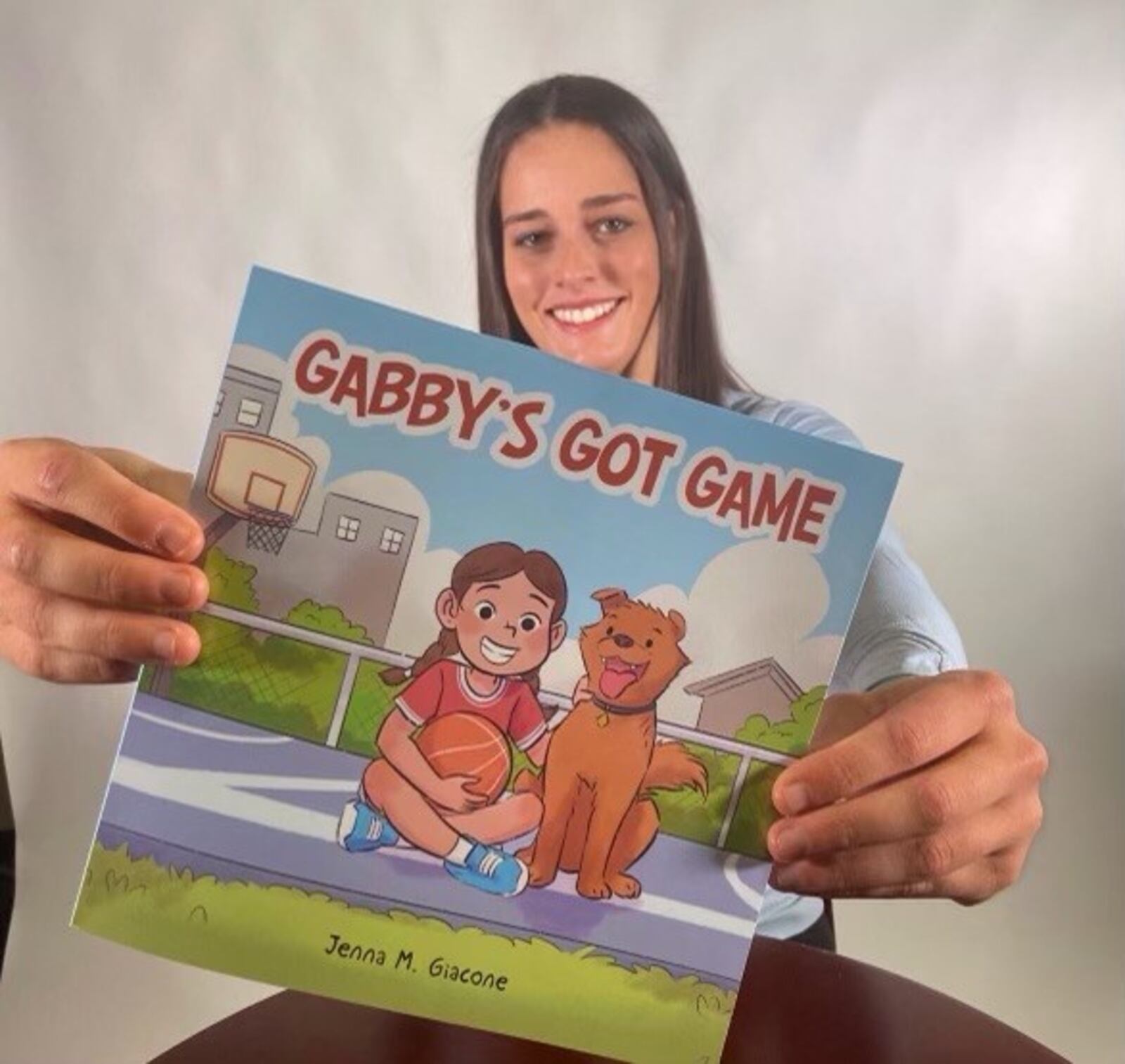 University of Dayton women's basketball player Jenna Giacone and the children's book she wrote, "Gabby's Got Game." CONTRIBUTED