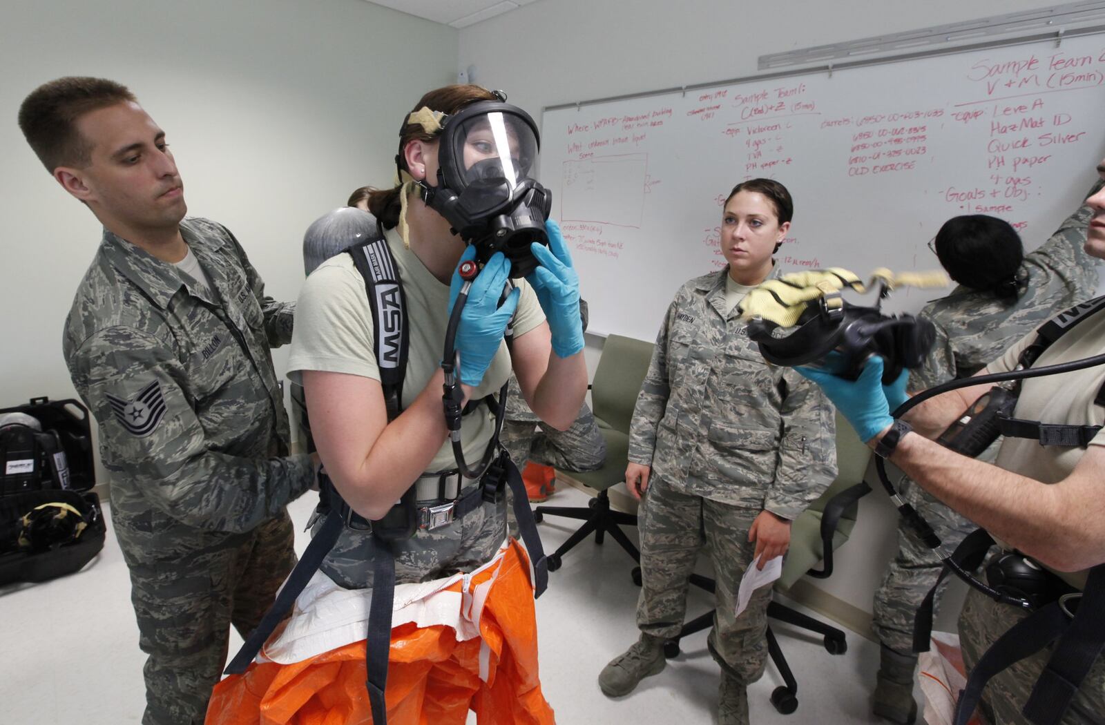 Students at the U.S. Air Force School of Aerospace Medicine practice hazardous materials scenarios in the apprentice program. In this Dayton Daily News file photo, Airman 1st Class Jane Vierzen wore full hazmat suits with a respirator to complete her site reconnaissance health risk assessment training. TY GREENLEES/STAFF