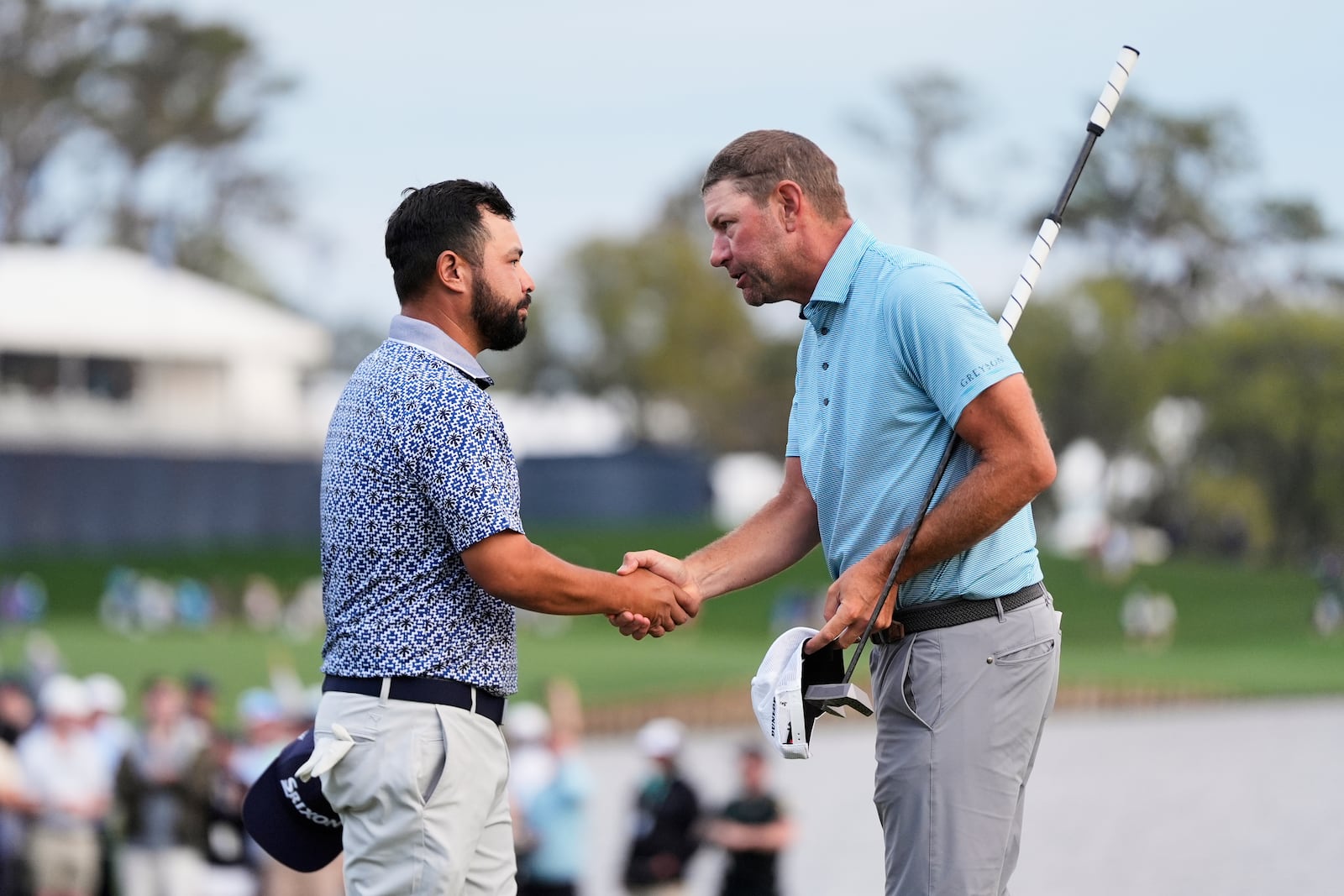 J.J. Spaun, left, greets Lucas Glover after the finish the 18th hole during the final round of The Players Championship golf tournament Sunday, March 16, 2025, in Ponte Vedra Beach, Fla. (AP Photo/Julia Demaree Nikhinson)