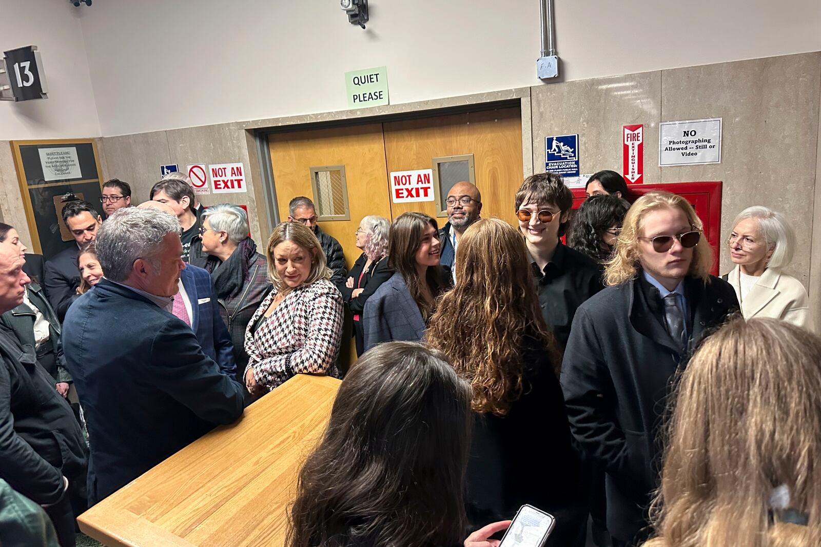 People wait in the courthouse during the murder trial of Nima Momemi, Tuesday, Dec. 17, 2024 in San Francisco. (AP Photo/Janie Har)