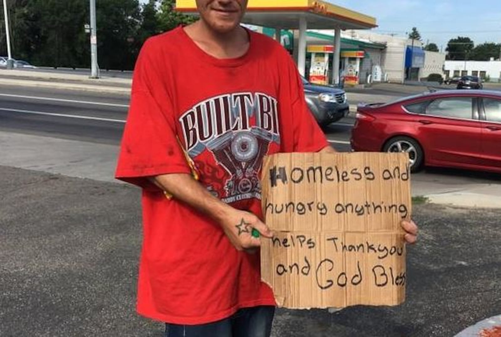 A Dayton panhandler shows his sign. CORNELIUS FROLIK / STAFF