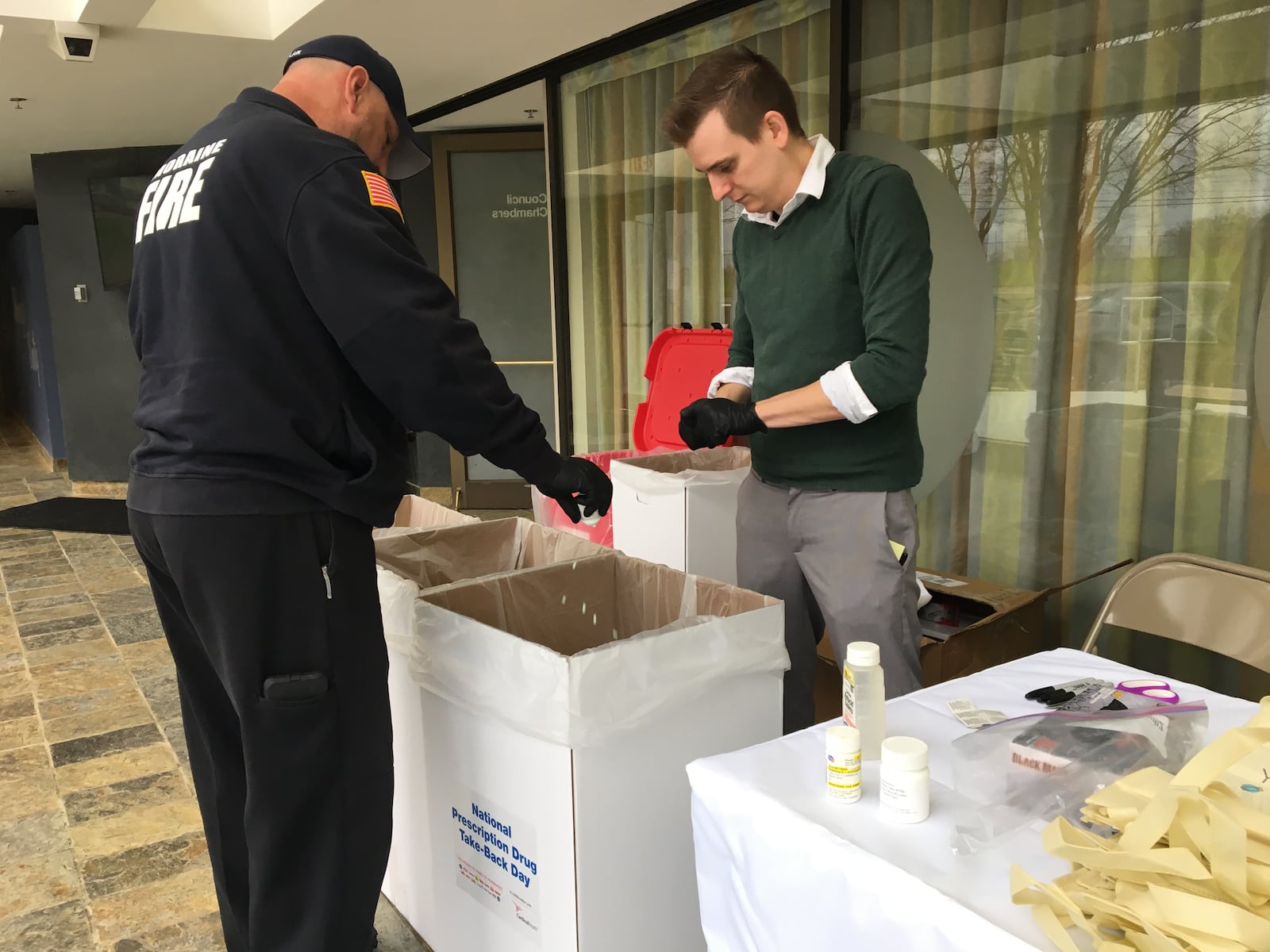 City of Moraine employees dump out unused pills turned in by residents on National Prescription Drug Take Back Day, April 28, 2018.  KATIE WEDELL/STAFF