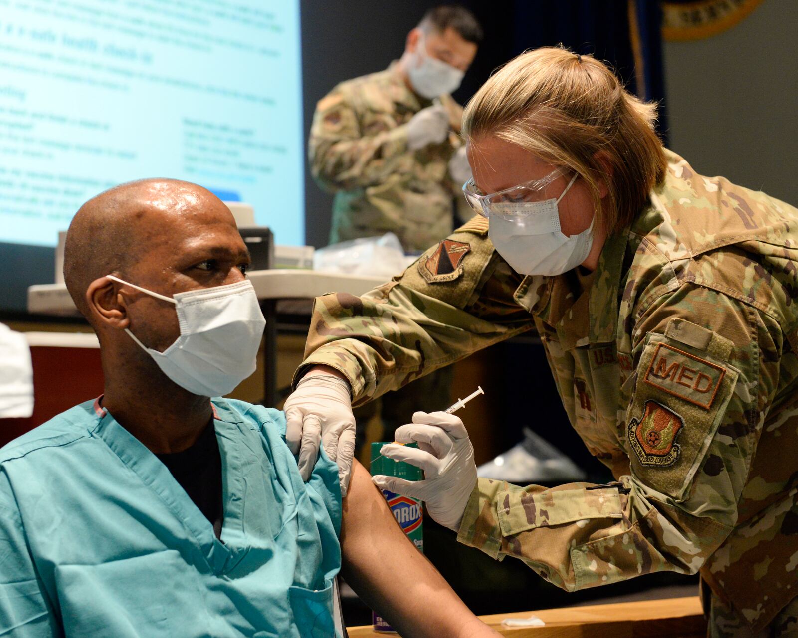 U.S. Air Force Maj. Kito Brooks, 88th Medical Group, podiatrist, receives the COVID-19 vaccine from Capt. Erica Eyer, 88MDG, flight commander, Aerospace Operational Medicine Clinic at Wright-Patterson Air Force Base on Jan. 4, 2021. (U.S. Air Force photo by Ty Greenlees)