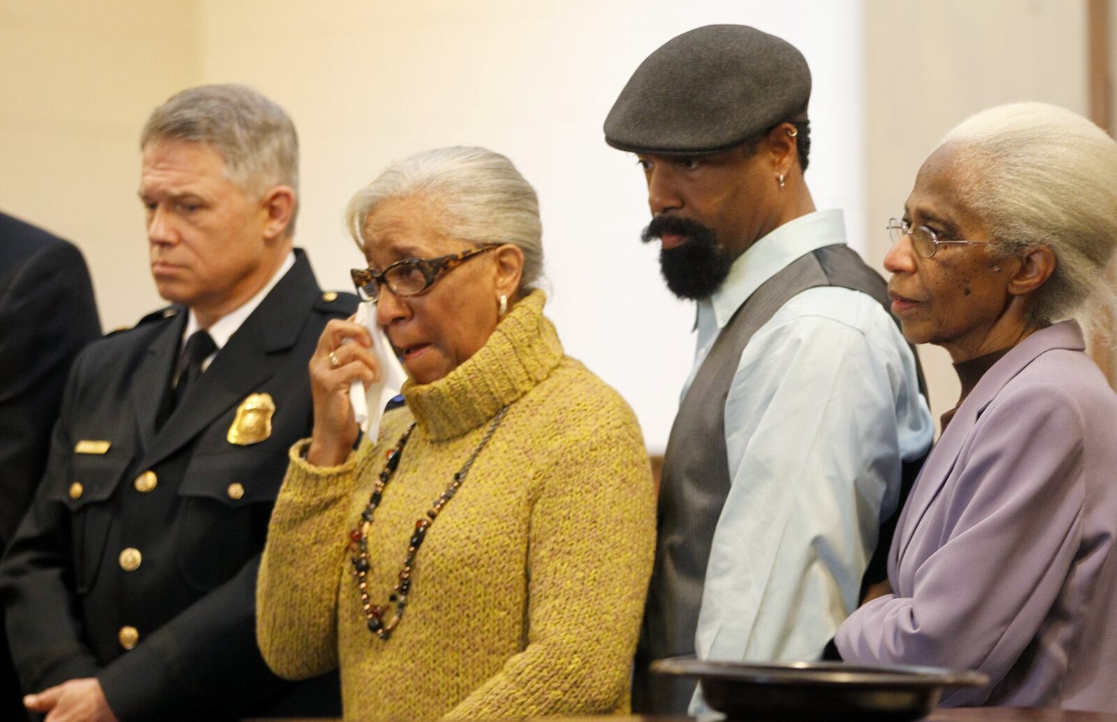 Rosemary Brame, the mother of slain Dayton Police Officer Kevin Brame, wipes away tears during a remembrance for her son in 2014 at Zion Baptist Church in Dayton. The event marked the 15th anniversary of Officer Brame’s unsolved homicide. From left to right are Dayton Police Chief Richard Biehl, Rosemary Brame, Kerry Brame, the brother of Officer Brame and Margaret Peters, Officer Brame’s aunt. LISA POWELL / STAFF PHOTO