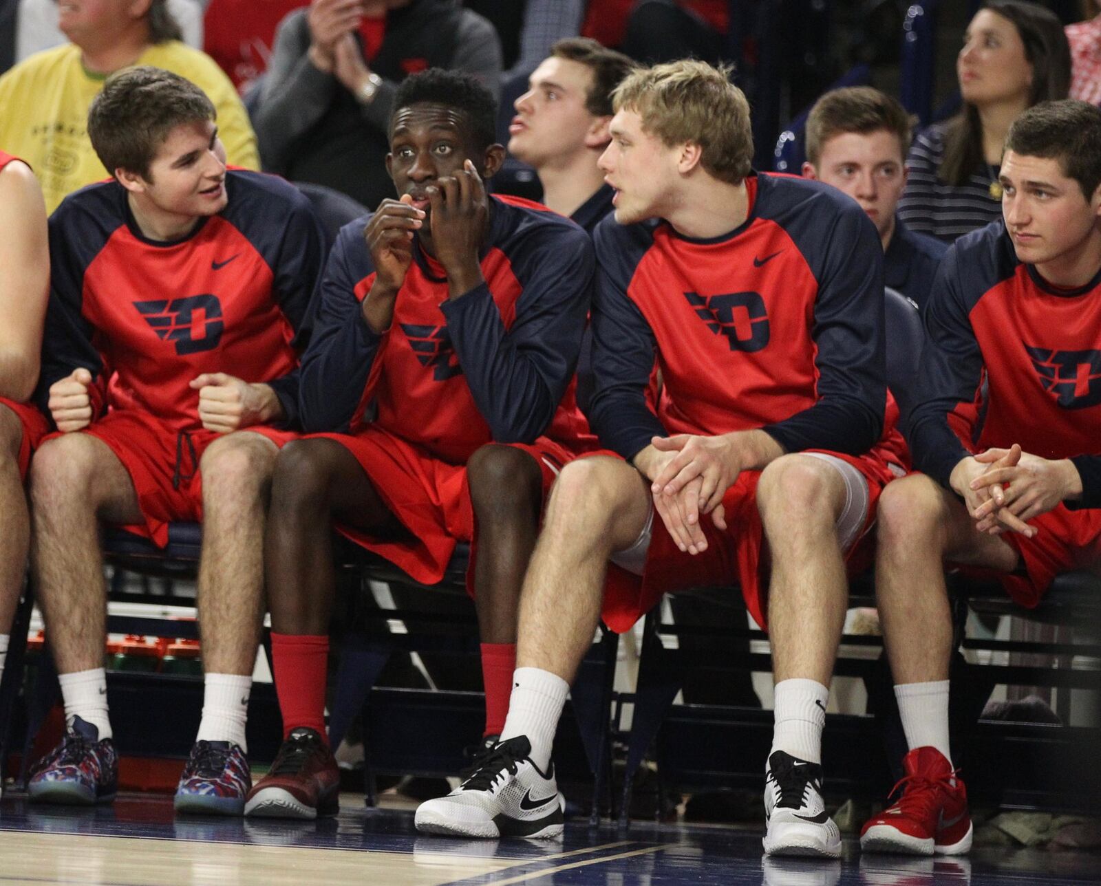 Dayton players (left to right: Joey Gruden, Jeremiah Bonsu, Michael Schwieterman and Jack Westerfield) watch from the bench during a game against Richmond on Tuesday, March 1, 2016, at the Robins Center in Richmond, Va. David Jablonski/Staff