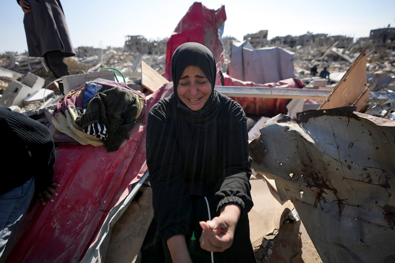 Manual Aslim reacts over the ruins of her destroyed home, in Rafah, southern Gaza Strip, Tuesday, Jan. 21, 2025, days after the ceasefire deal between Israel and Hamas came into effect. (AP Photo/Abdel Kareem Hana)