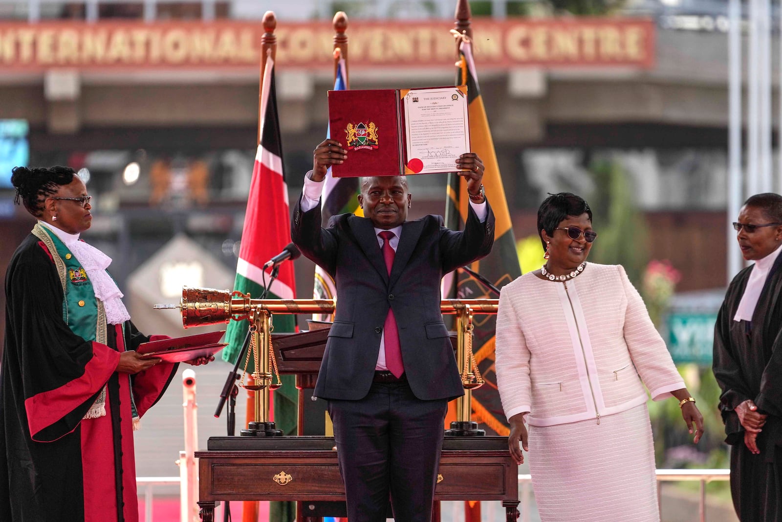 Kenya's new Deputy President Kithure Kindiki, center, is sworn into office at a ceremony held at Kenyatta International Convention Centre, in Nairobi, Kenya Friday, Nov. 1, 2024. (AP Photo/Brian Inganga)