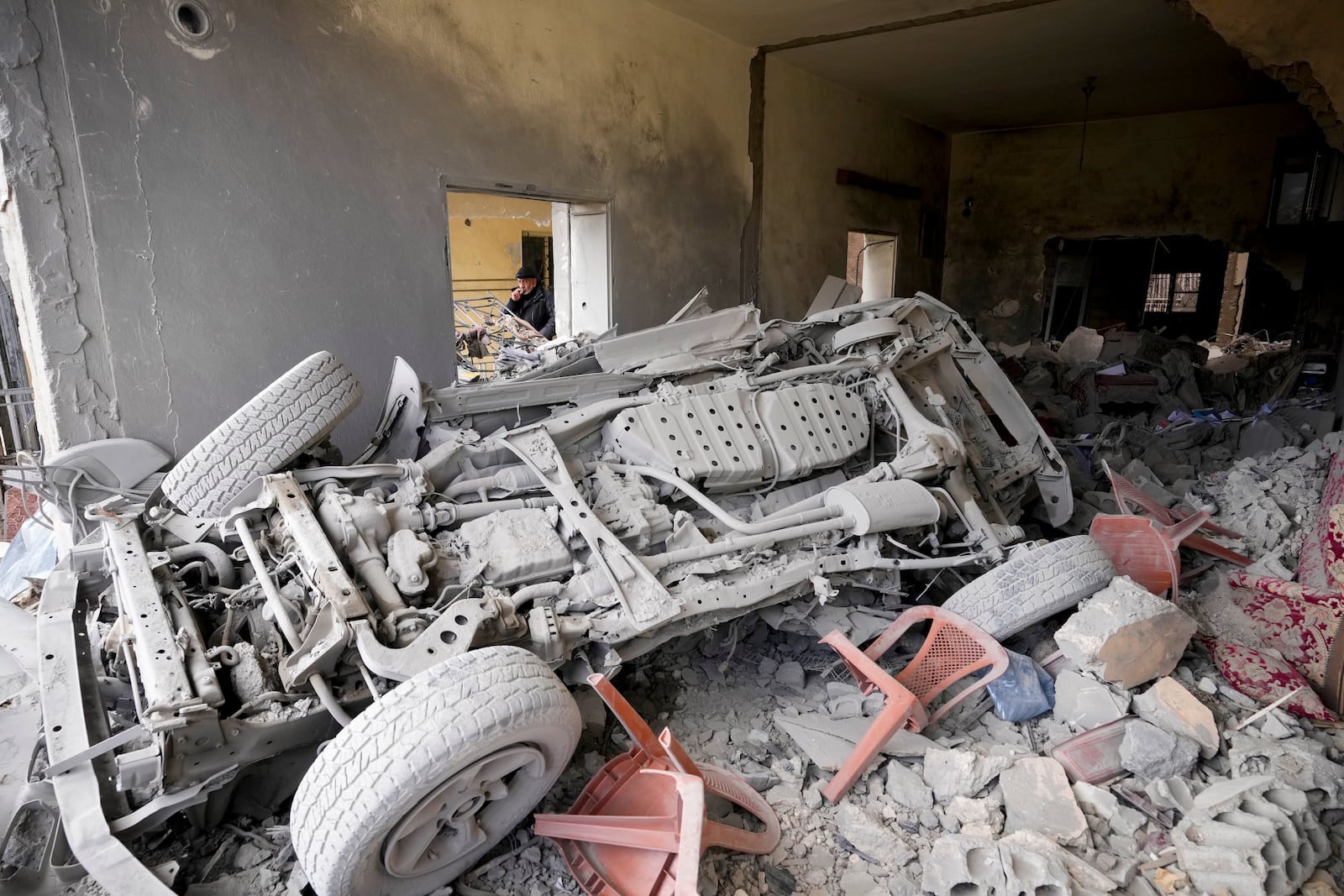 A man inspects a house damaged in Israeli airstrikes, in Baalbek, eastern Lebanon, Thursday, Nov. 28, 2024. (AP Photo/Hassan Ammar)