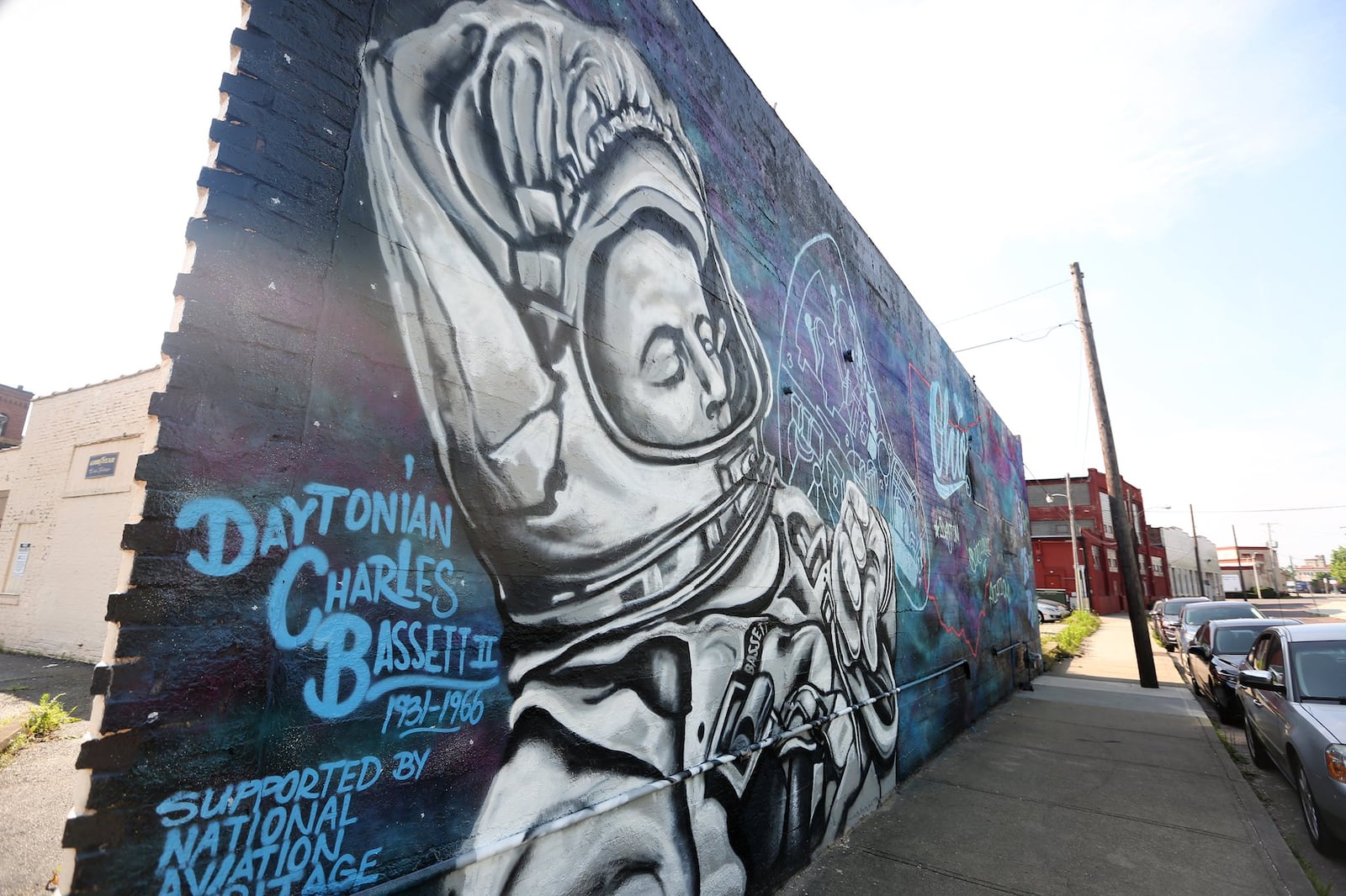 A new mural dedicated to NASA astronaut Charles Bassett II has been installed at the corner of Wyandot and Third streets in downtown Dayton. Bassett was a Dayton native and former U.S. Air Force pilot who died with fellow astronaut Elliot See Jr. on Feb. 28, 1966, when the T-38 jet they were aboard struck the building housing their space capsule in St. Louis, Mo. The design, created and painted by Tiffany Clark of the Mural Machine, includes a rendering of Bassett in his space suit and stats about Ohio’s space history. LISA POWELL / STAFF