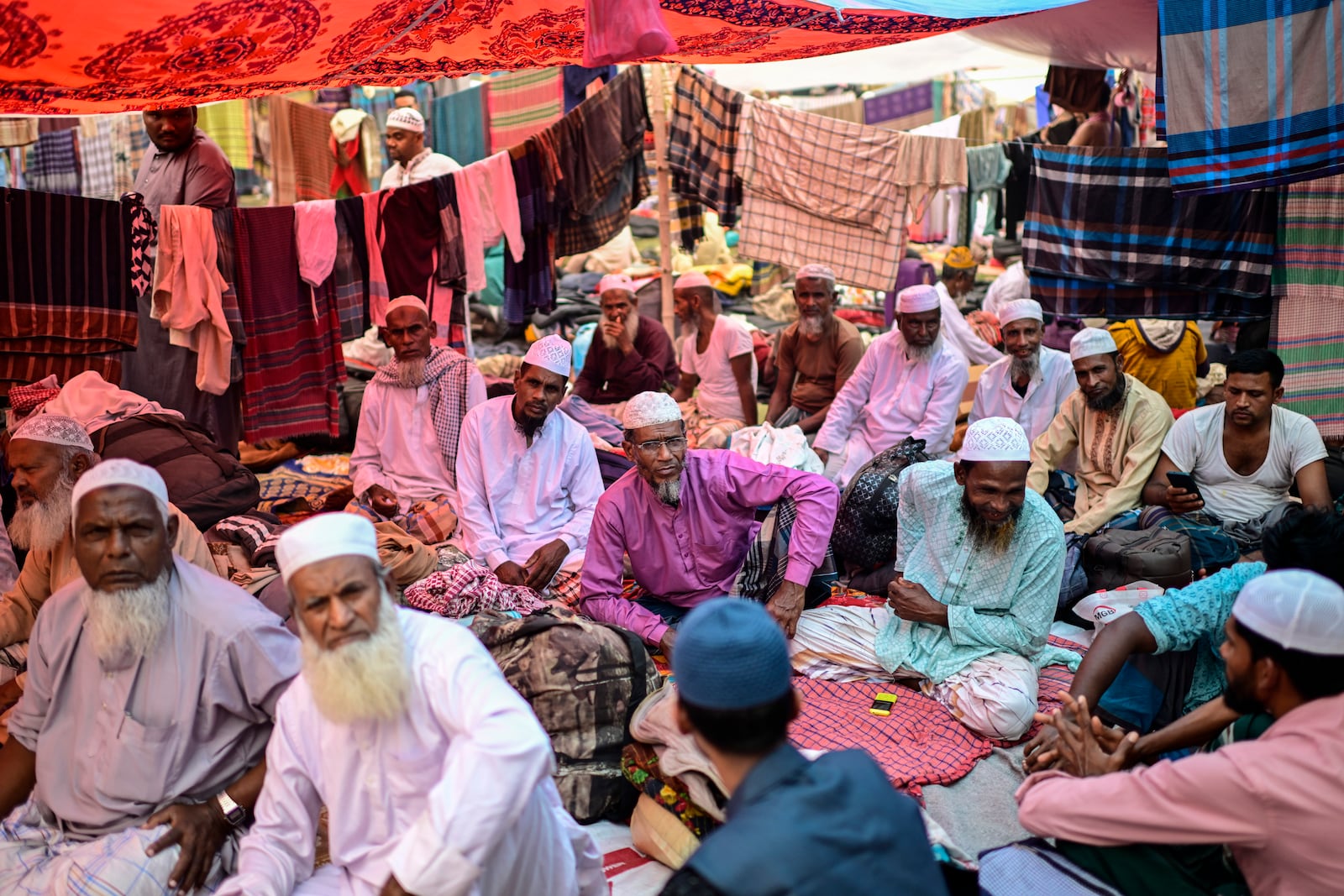 Muslim devotees rest in a makeshift tent during the first phase of the three-day Biswa Ijtema, or the World Congregation of Muslims, at the banks of the Turag river in Tongi, near Dhaka, Bangladesh, Friday, Jan. 31, 2025. (AP Photo/Mahmud Hossain Opu)