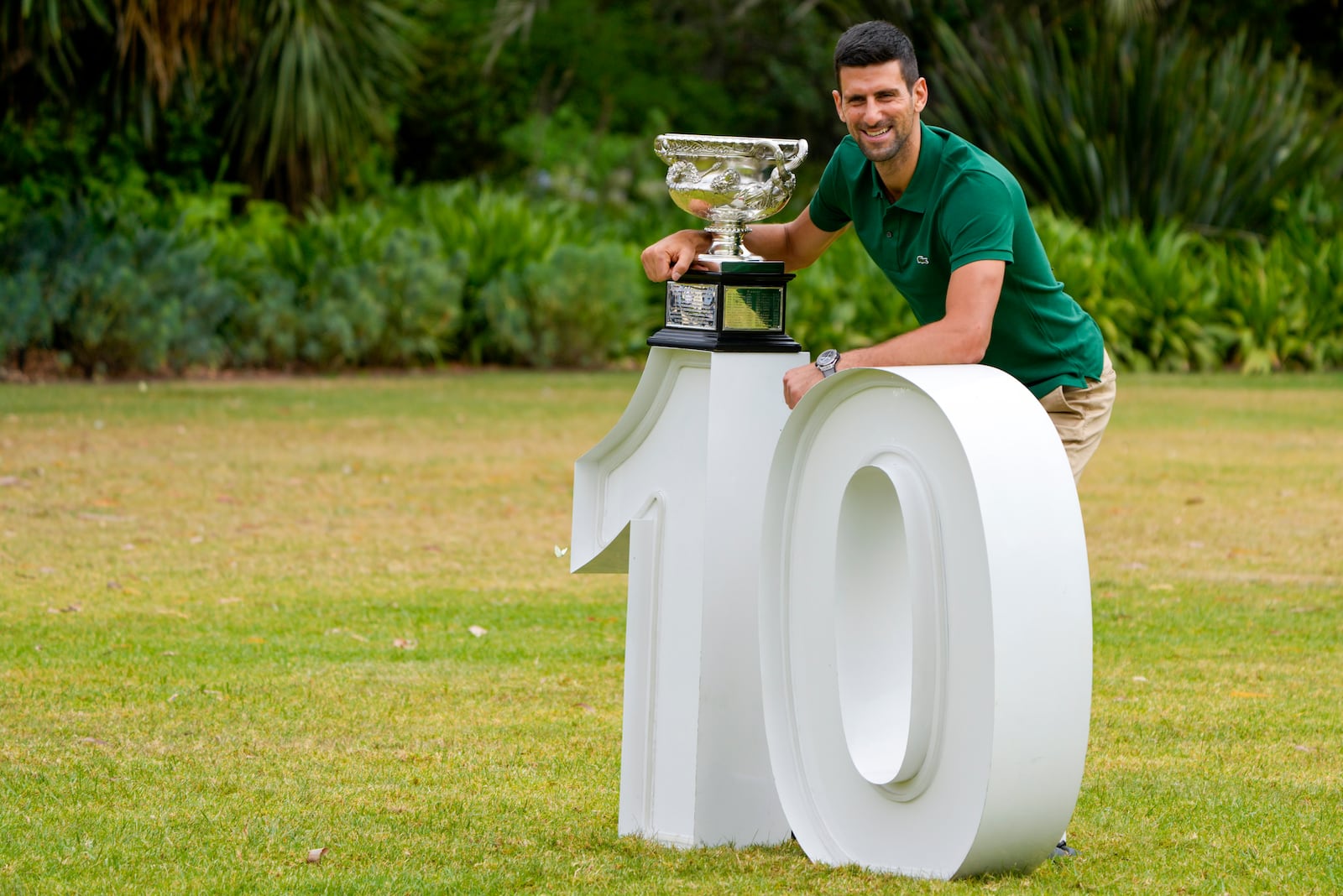 FILE - Novak Djokovic of Serbia poses with the Norman Brookes Challenge Cup in the gardens of Government House the morning after defeating Stefanos Tsitsipas of Greece in the men's singles final at the Australian Open tennis championship in Melbourne, Australia, Monday, Jan. 30, 2023. (AP Photo/Mark Baker, File)