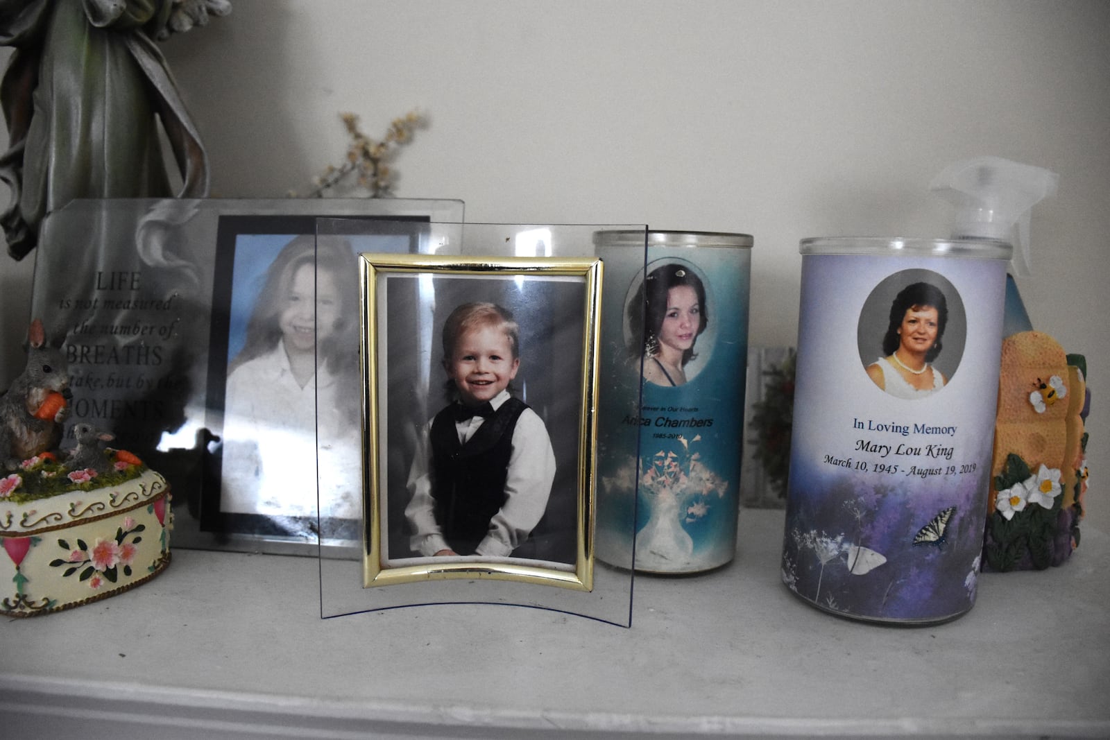 A photograph of Jack Flohres as a child. Flohres, who would be 31 years old today, went missing on Jan. 15, 2023. His photograph sits next to a memorial candle for his sister, Arica Chambers, who died of a drug overdose in 2010, according to her family. CORNELIUS FROLIK / STAFF