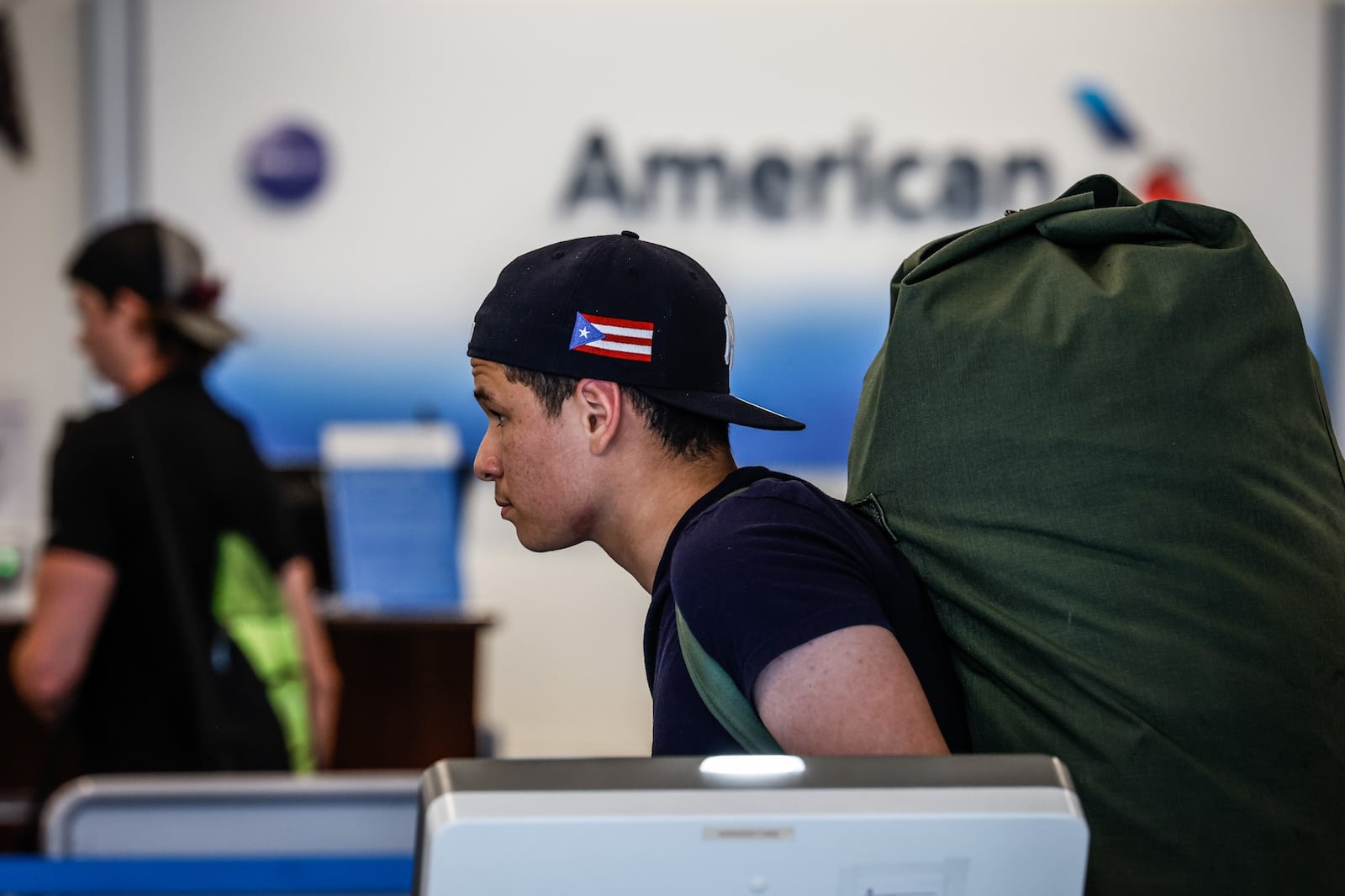 Pedro Figueroa, from the Bronx in New York City, waits inline at American Airlines ticket counter at the Dayton International Airport Friday July 15, 2022. JIM NOELKER/STAFF