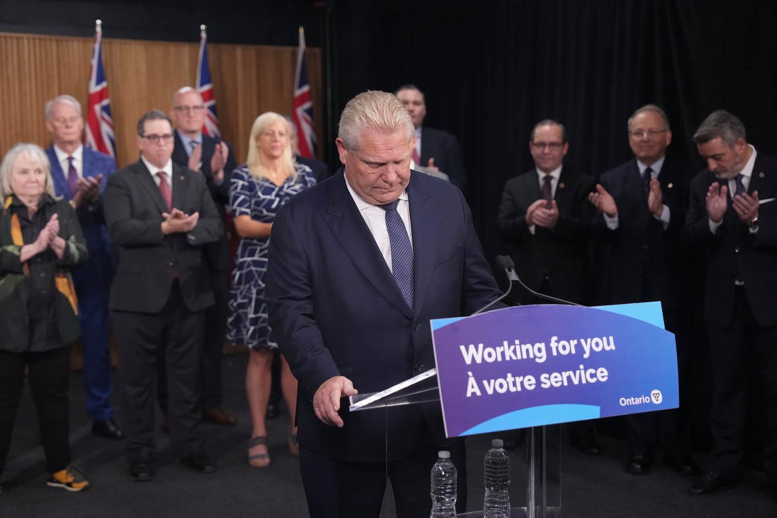 Ontario Premier Doug Ford speaks to members of the media as mayors from selected municipalities and government ministers look on the Queen's Park Legislature in Toronto on Thursday Dec. 12, 2024. (Chris Young/The Canadian Press via AP)