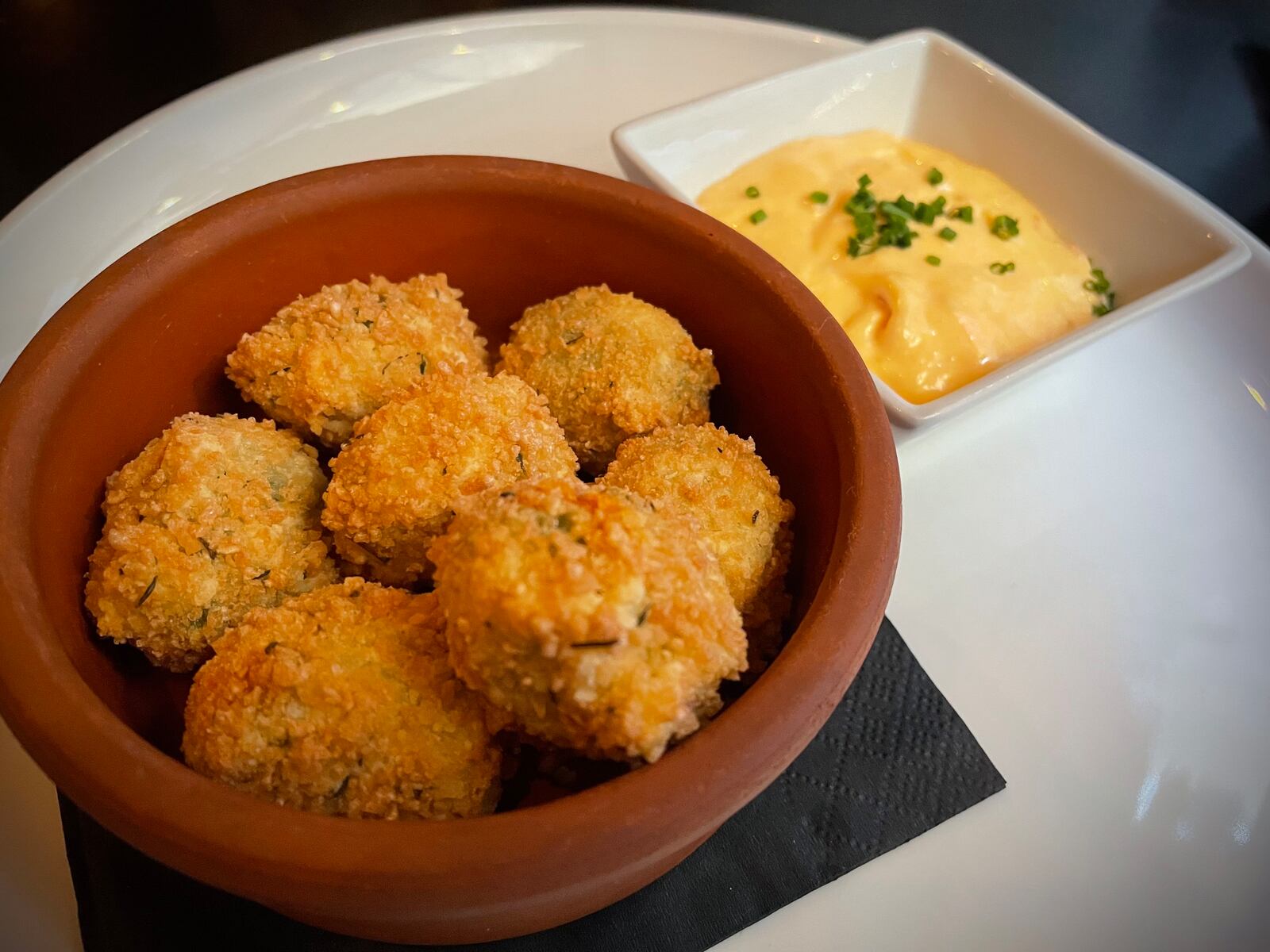 Roost Modern Italian in Dayton’s Oregon District has been rebranded as Culina, an Italian-inspired small plates restaurant and bar. Pictured is the Frizzled N'Duja Stuffed Cerignola Olives. NATALIE JONES/STAFF