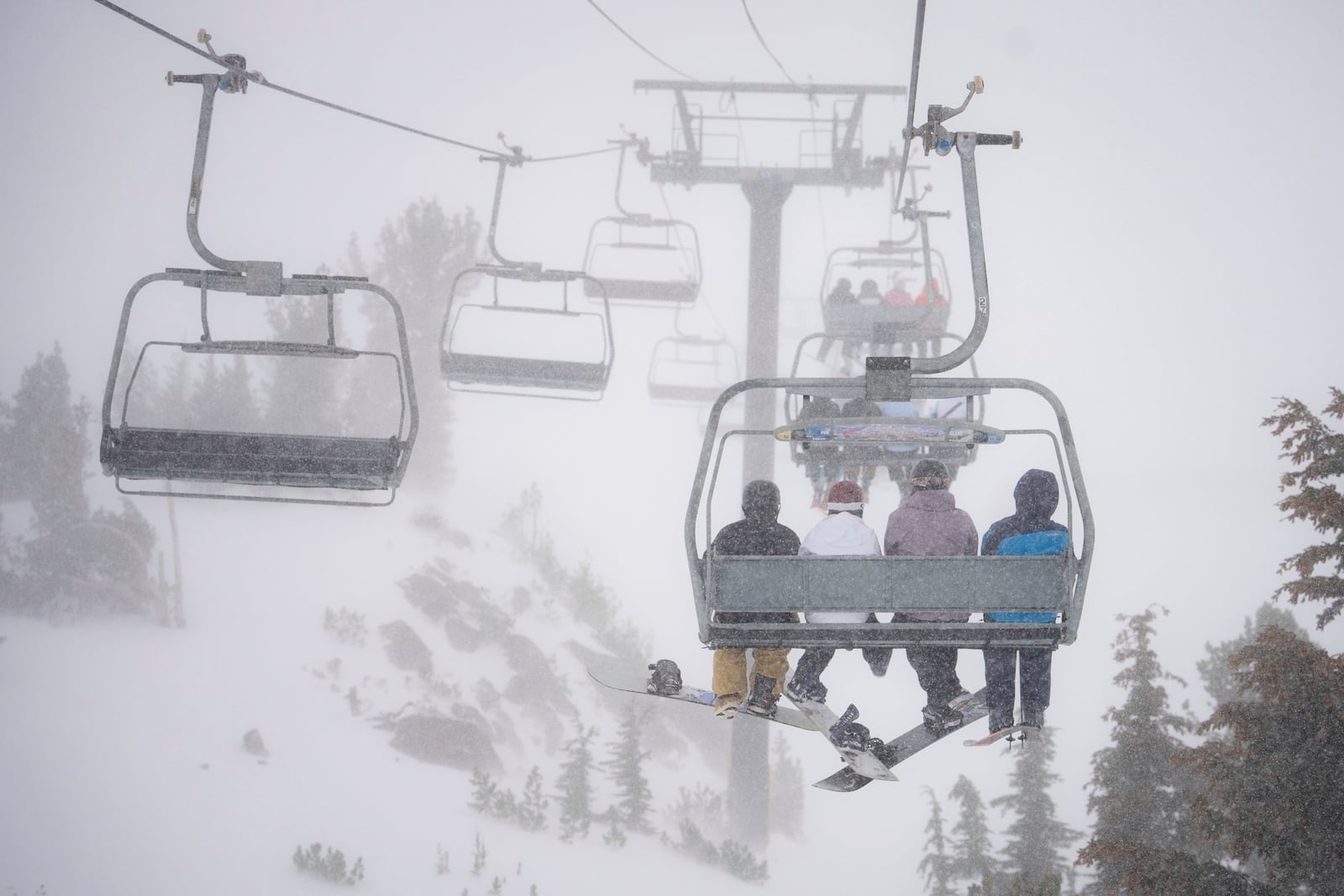 FILE - Skiers go up a lift in a snowstorm on Mammoth Mountain in Mammoth Lakes, Calif., Dec. 14, 2024. (Christian Pondella/Mammoth Mountain Ski Area via AP, File)