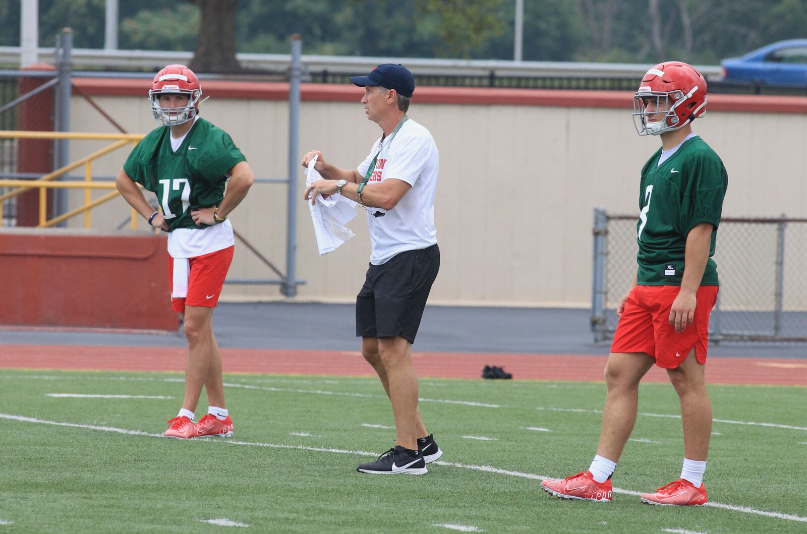 Dayton's Jim Collins, center, coaches at the first practice of the season on Monday, Aug. 9, 2021, in Dayton. David Jablonski/Staff