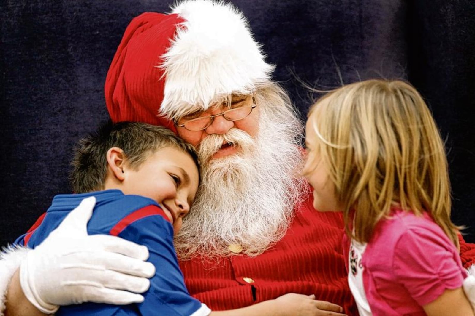 Santa Claus talks with children at the Mall at Fairfield Commons in this file photo. This year, visits with Santa will be more socially distanced. STAFF FILE PHOTO