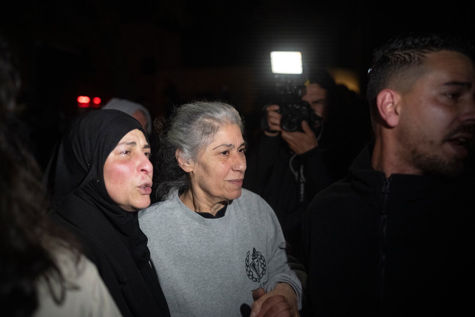 Khalida Jarrar, 62, a leading member of the Popular Front for the Liberation of Palestine, is greeted after disembarking from a bus following her release from an Israeli prison, in the West Bank city of Beitunia, early Monday, Jan. 20, 2025. (AP Photo/Leo Correa)