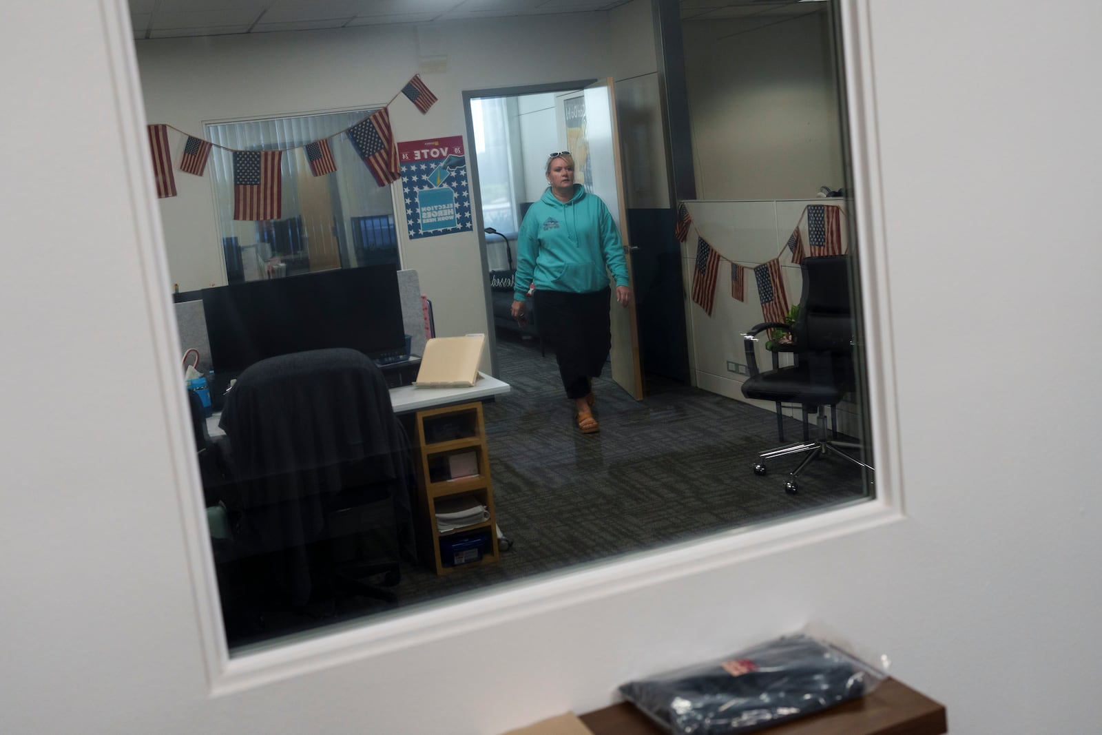 Cari-Ann Burgess, interim Registrar of Voters for Washoe County, Nev., walks through the office Saturday, Sept. 21, 2024, in Reno, Nev. (AP Photo/John Locher)