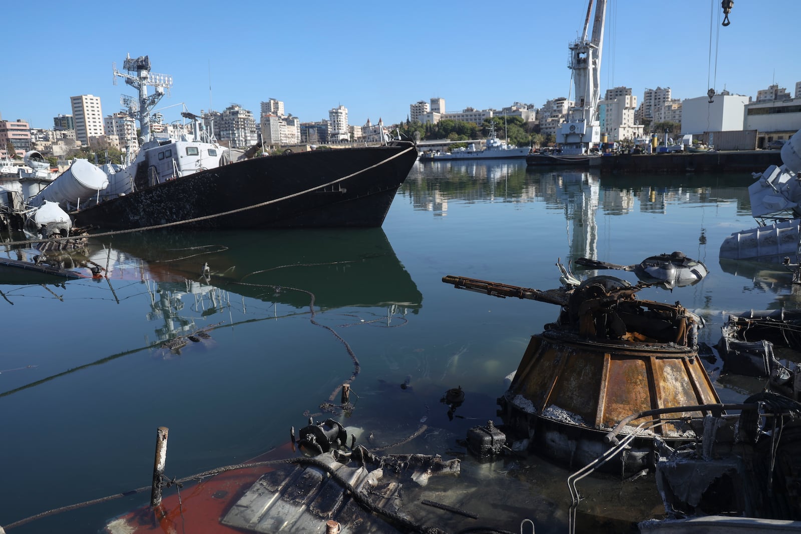 Syrian naval vessels and small civilian ships are seen destroyed by an Israeli airstrike last week in the port of Latakia, Syria, Saturday, Dec. 14, 2024. (AP Photo/Omar Albam)