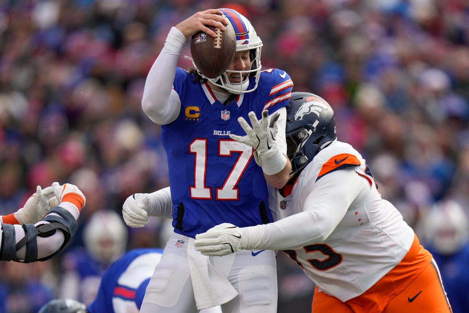 Buffalo Bills quarterback Josh Allen (17) is tackled by Denver Broncos defensive tackle D.J. Jones (93) during the third quarter of an NFL wild card playoff football game, Sunday, Jan. 12, 2025, in Orchard Park, N.Y. (AP Photo/Seth Wenig)