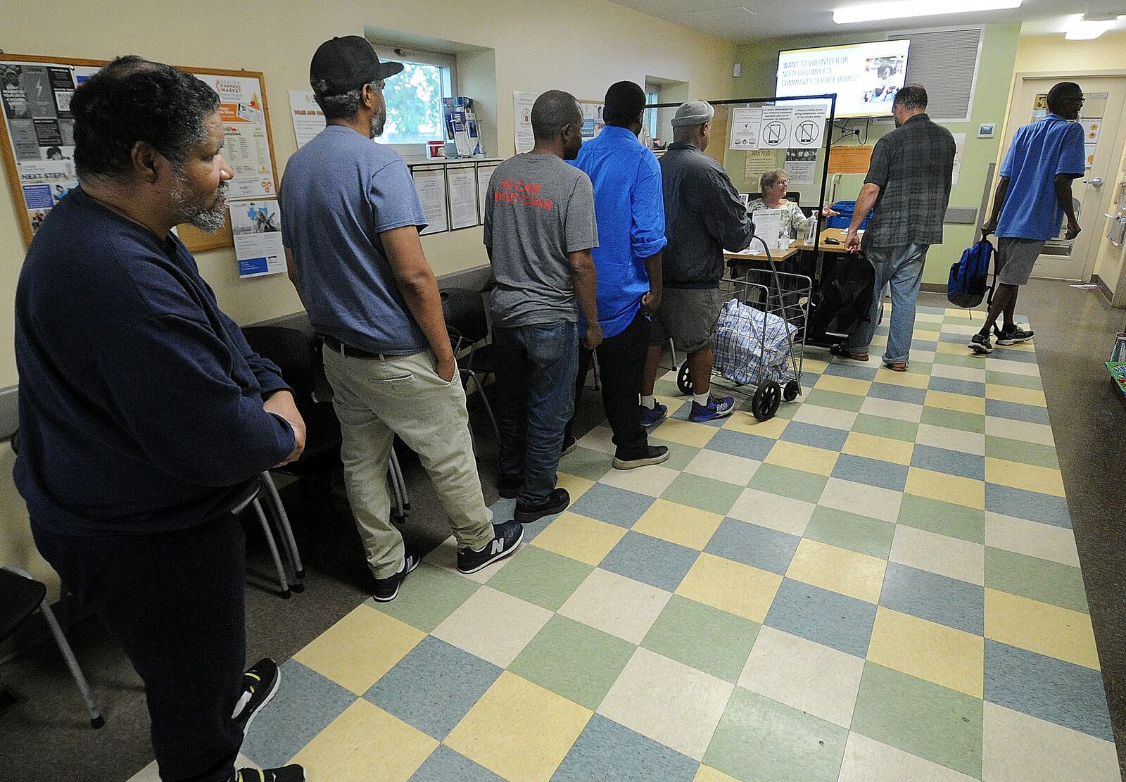 People line up at the Catholic Social Services of the Miami Valley's Choice Food Pantry to receive free groceries Thursday,  July 6, 2023. MARSHALL GORBY\STAFF