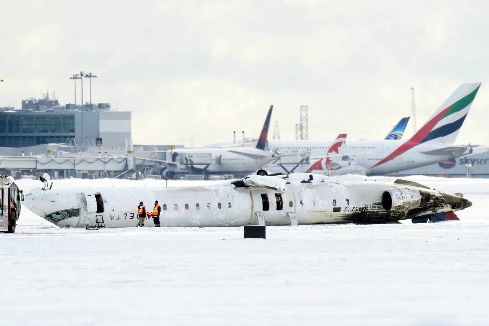 A Delta Air Lines plane lies upside down at Toronto Pearson Airport on Tuesday, Feb. 18, 2025. (Chris Young/The Canadian Press via AP)