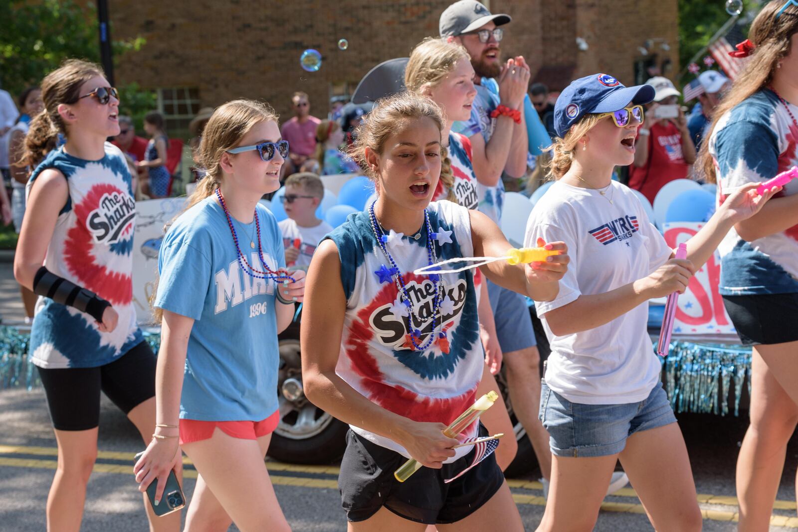 Centerville-Washington Twp. Americana Festival parade participants walk through Uptown Centerville Tuesday, July 4, 2023. The festival, which got its start in 1972, attracts more than 85,000 visitors annually. TOM GILLIAM/CONTRIBUTING PHOTOGRAPHER