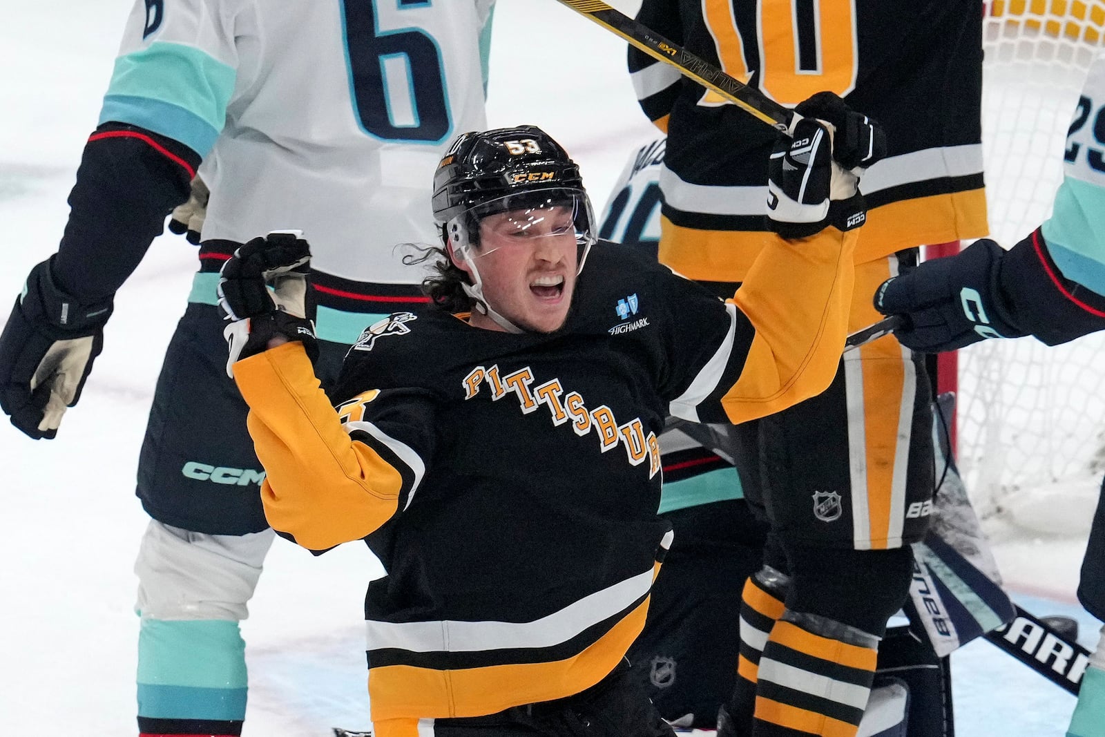 Pittsburgh Penguins' Philip Tomasino celebrates his goal during the first period of an NHL hockey game against the Seattle Kraken in Pittsburgh, Tuesday, Jan. 14, 2025. (AP Photo/Gene J. Puskar)