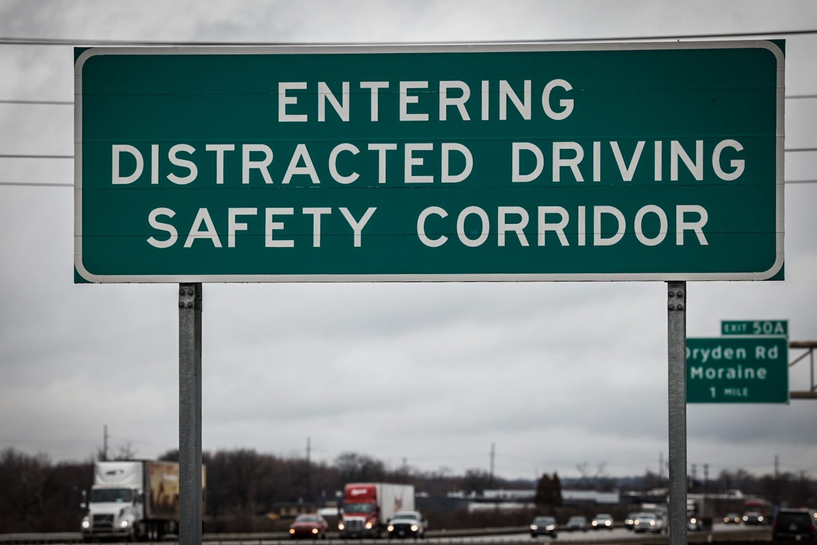 A large sign on the northbound side of Interstate 75 near West Carrollton warns drivers they are entering a distracted driving safety corridor. JIM NOELKER/STAFF