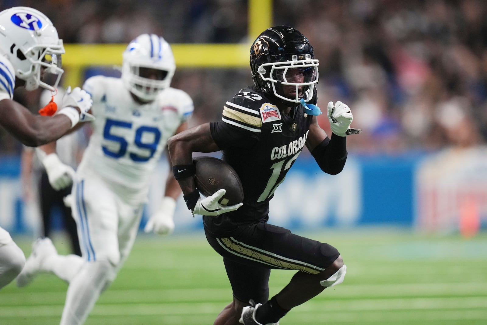 Colorado wide receiver Travis Hunter (12) runs for a touchdown against BYU after making a catch during the second half of the Alamo Bowl NCAA college football game, Saturday, Dec. 28, 2024, in San Antonio. (AP Photo/Eric Gay)