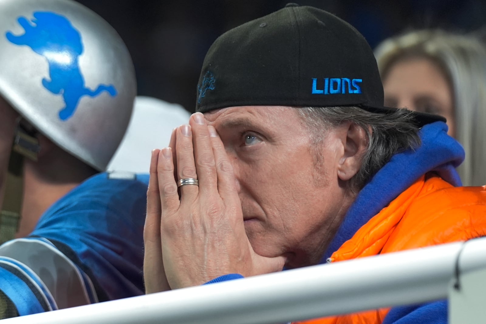 A Detroit Lions fan watches against the Washington Commanders during the second half of an NFL football divisional playoff game, Saturday, Jan. 18, 2025, in Detroit. (AP Photo/Seth Wenig)