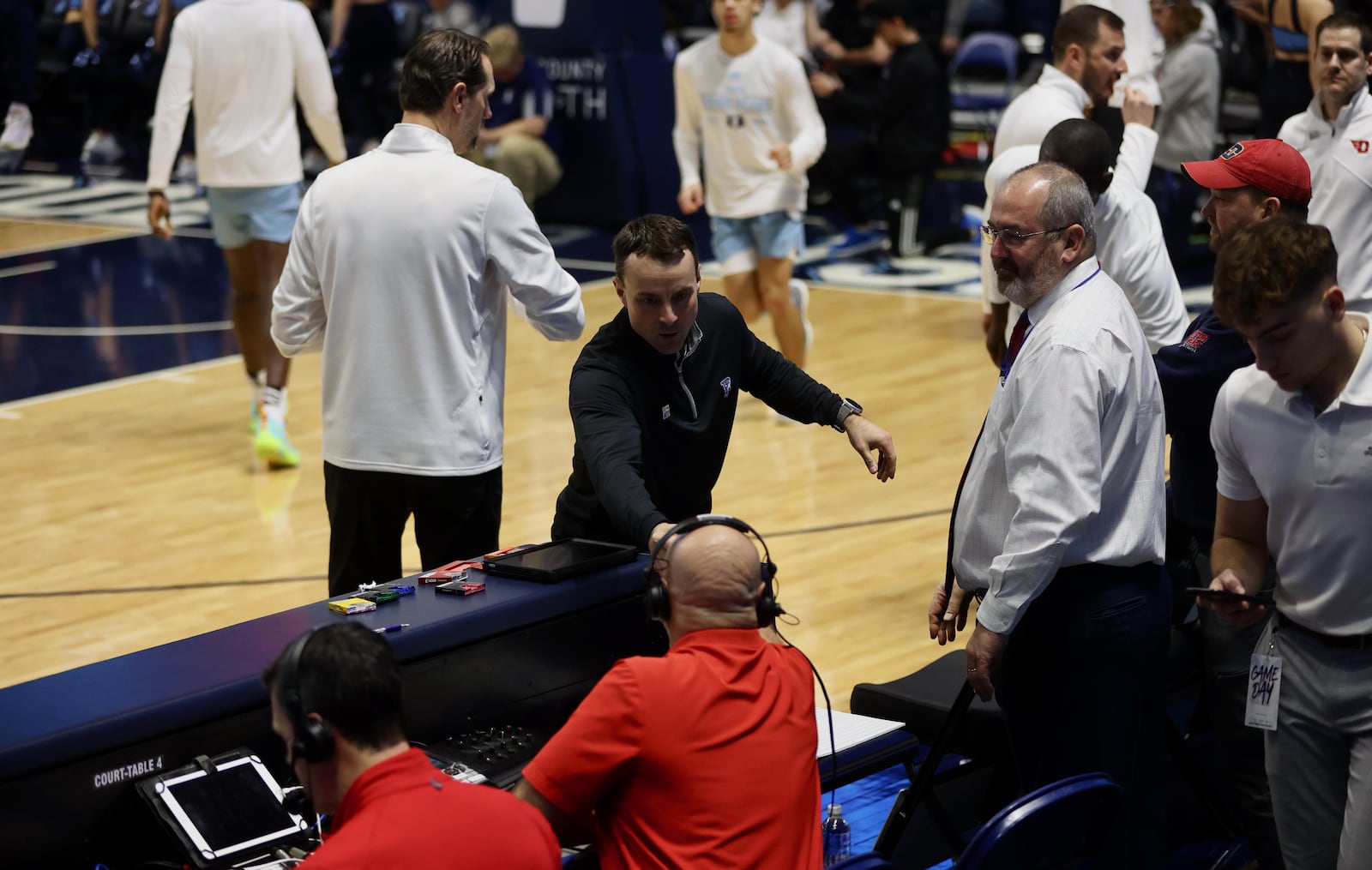 Rhode Island's Archie Miller shakes hands with WHIO's Larry Hansgen before the game on Wednesday, Jan. 25, 2023, at the Ryan Center in Kingston, R.I. David Jablonski/Staff