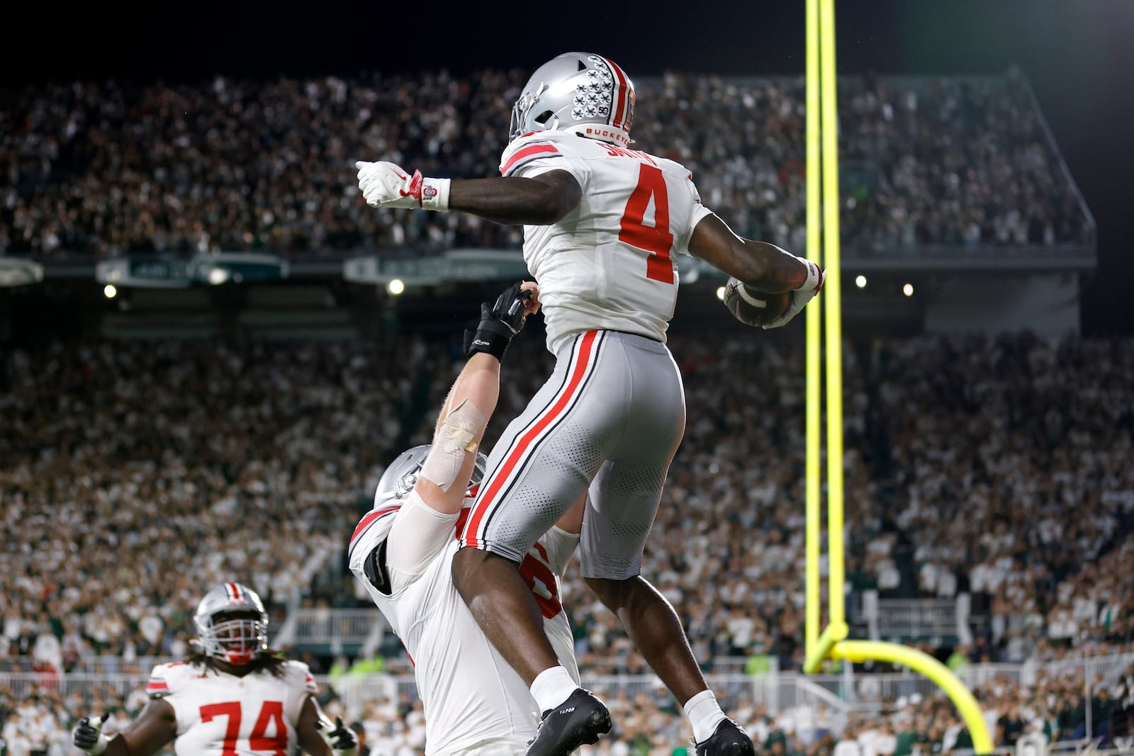 FILE - Ohio State wide receiver Jeremiah Smith (4) and offensive lineman Seth McLaughlin celebrate Smith's touchdown during the first half of an NCAA college football game, Saturday, Sept. 28, 2024, in East Lansing, Mich. (AP Photo/Al Goldis, File)