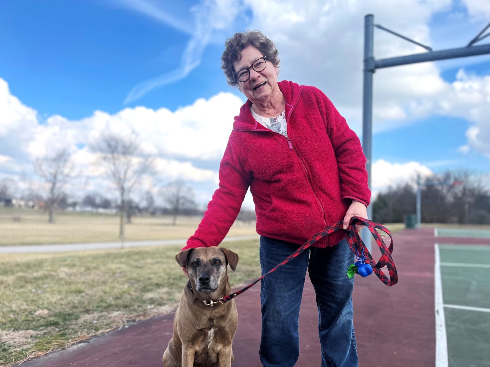 Lonnie Vilkas, 74, walks her dog, Amina, about twice a day at Belmont Park in southeast Dayton. CORNELIUS FROLIK / STAFF