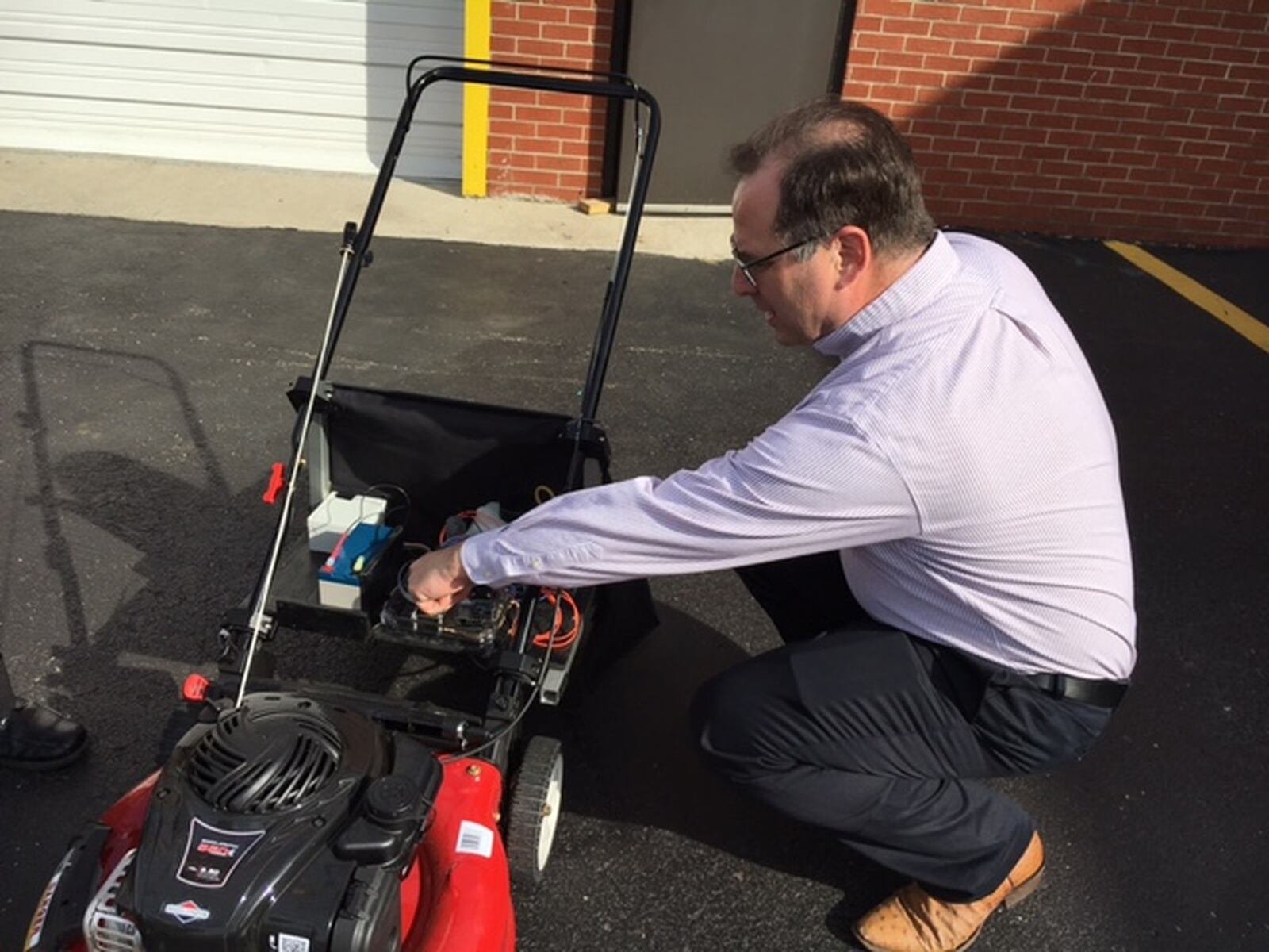 Jon Jackson, a Centerville inventor, explains the intricacies of his “NatureZapSmartSmartSpray,” which lets users mow and eradicate weeds, without chemicals, simultaneously. THOMAS GNAU/STAFF