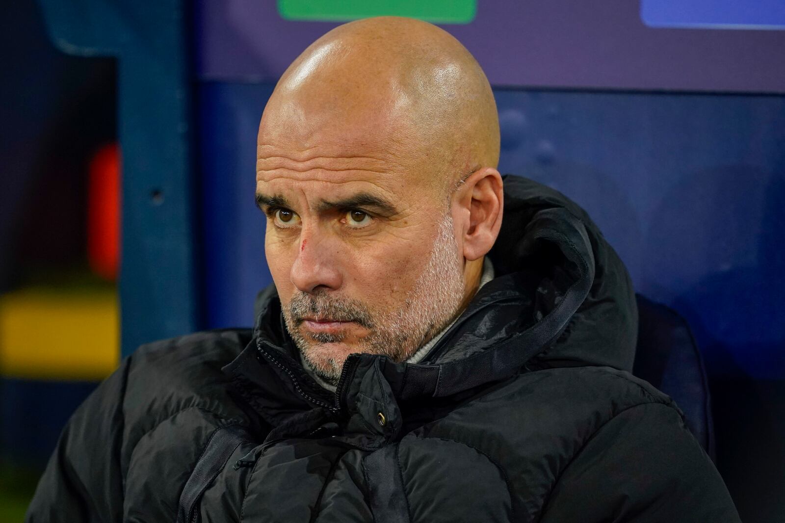 Manchester City's head coach Pep Guardiola takes his seat on the bench before the Champions League opening phase soccer match between Manchester City and Feyenoord at the Etihad Stadium in Manchester, England, Tuesday, Nov. 26, 2024. (AP Photo/Dave Thompson)