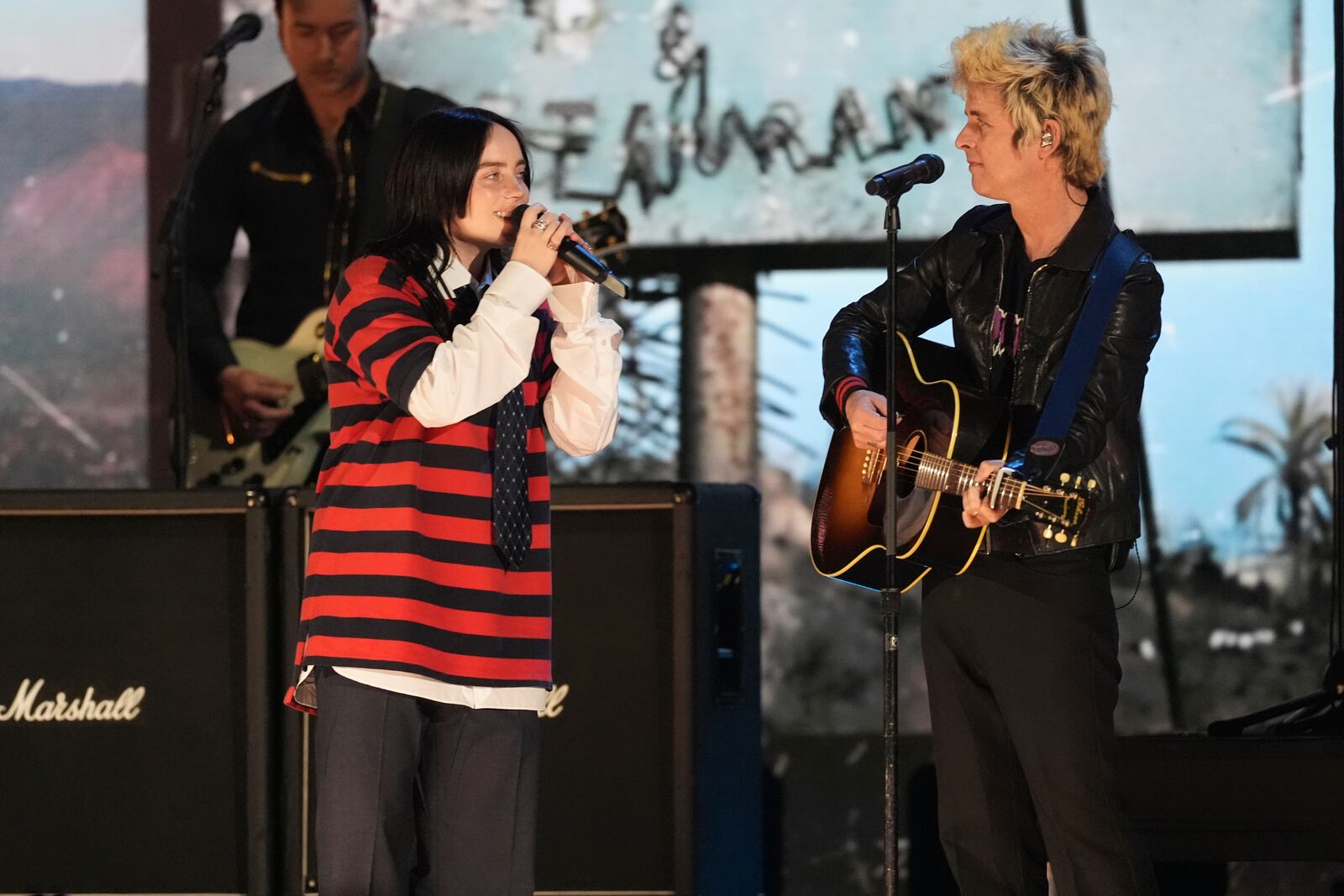 Billie Eilish, left, performs with Billie Joe Armstrong of Green Day during the FireAid benefit concert on Thursday, Jan. 30, 2025, at The Forum in Inglewood, Calif. (AP Photo/Chris Pizzello)