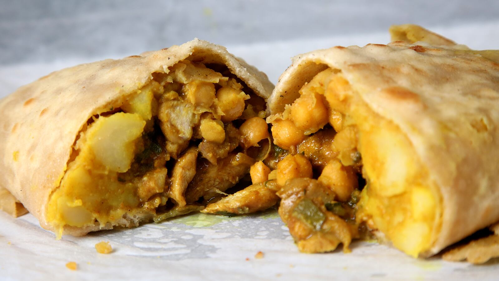 The Soca food truck's Roti is flatbread folded around a combination of curried potatoes, chickpeas and choice of meat, similar to a burrito. LISA POWELL / STAFF