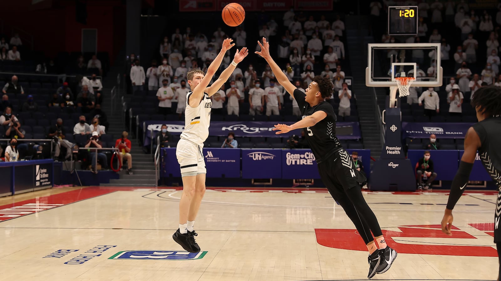 Cutline: Centerville High School sophomore Gabe Cupps shoots the ball over Westerville Central's Donovan Hunter during the Division I state championship game on Sunday night at UD Arena. Michael Cooper/CONTRIBUTED